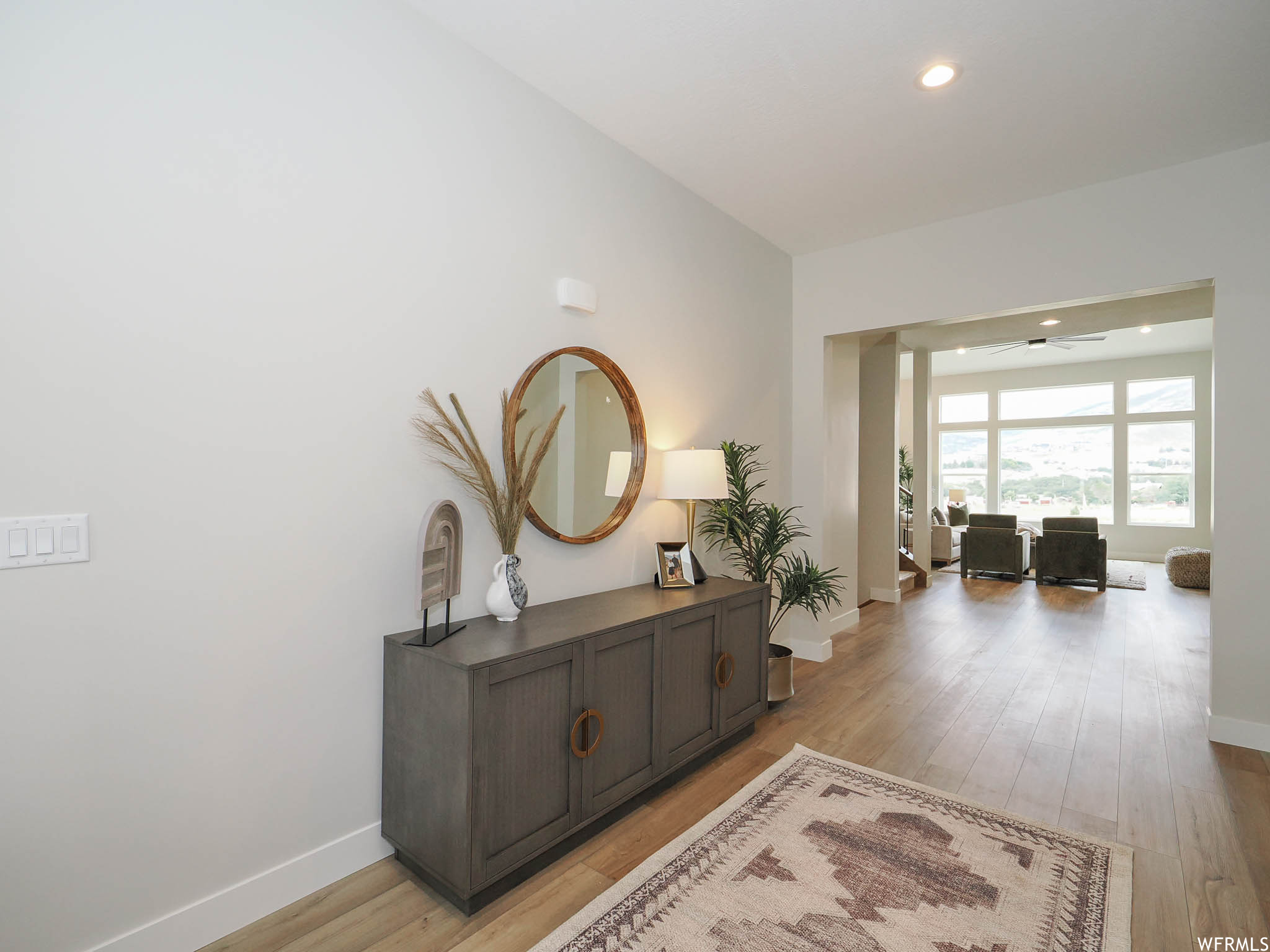 Hallway featuring light hardwood flooring