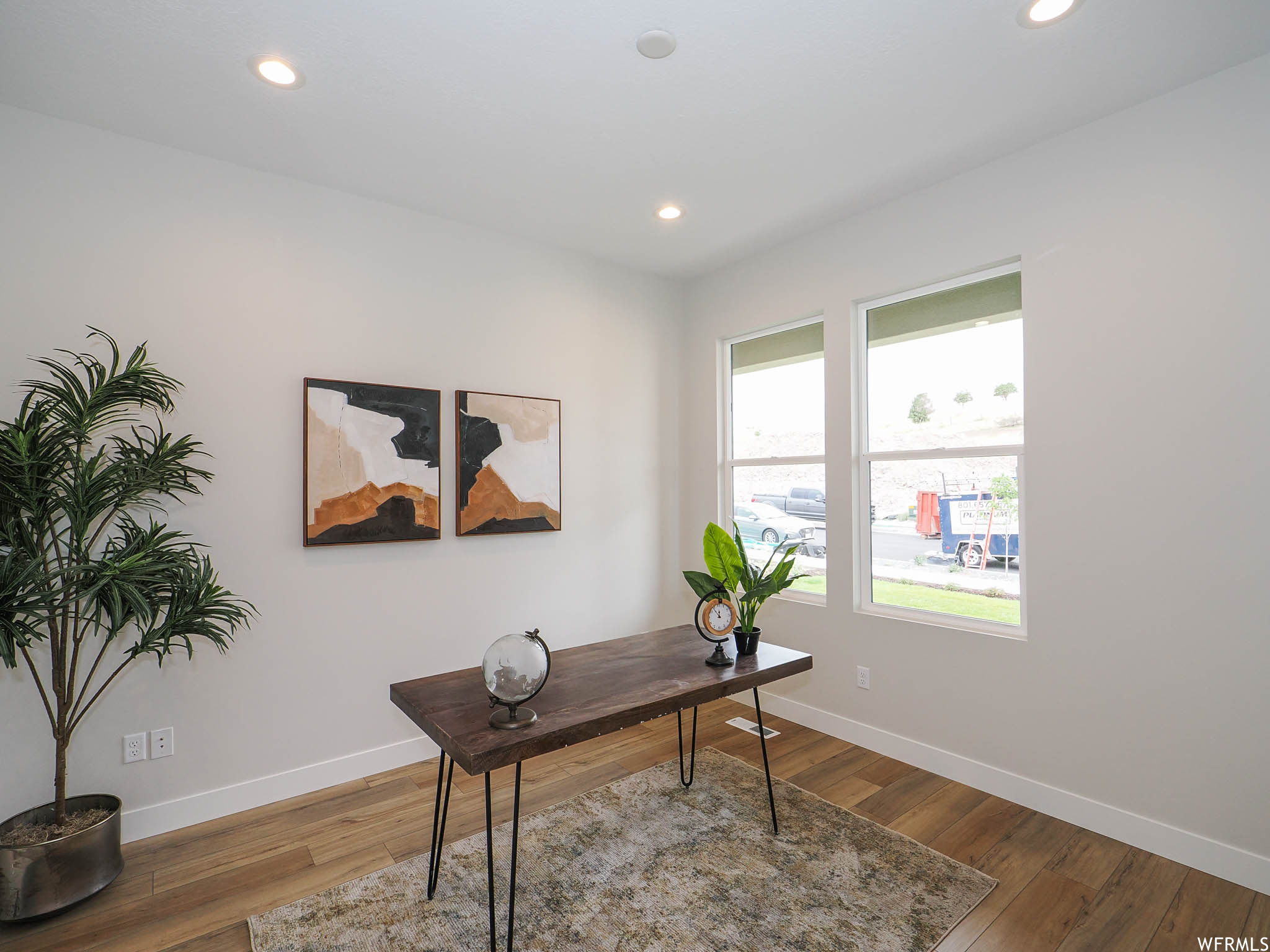 View of hardwood floored home office