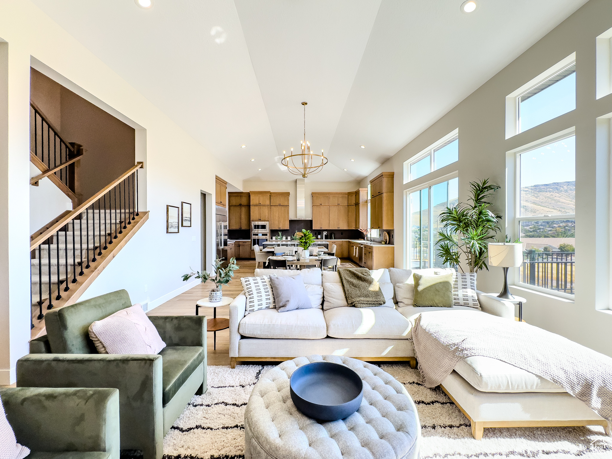 Living room featuring an inviting chandelier, a mountain view, and light hardwood / wood-style floors