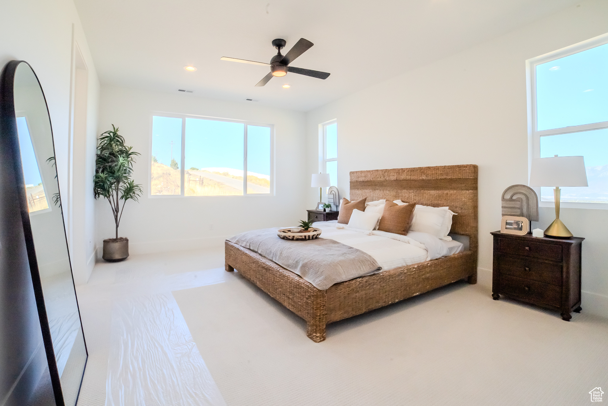 Carpeted bedroom with ceiling fan