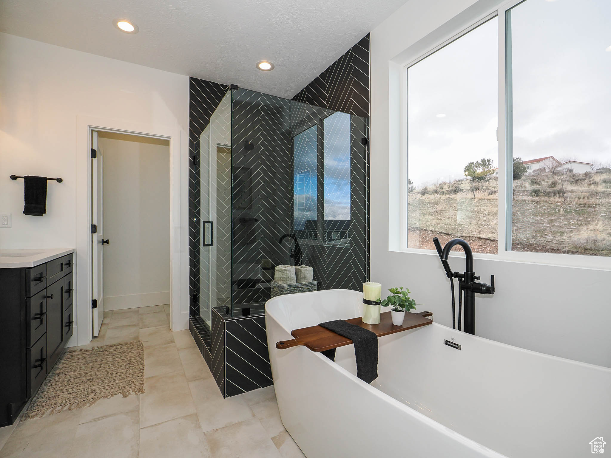 Bathroom featuring vanity, independent shower and bath, and tile floors