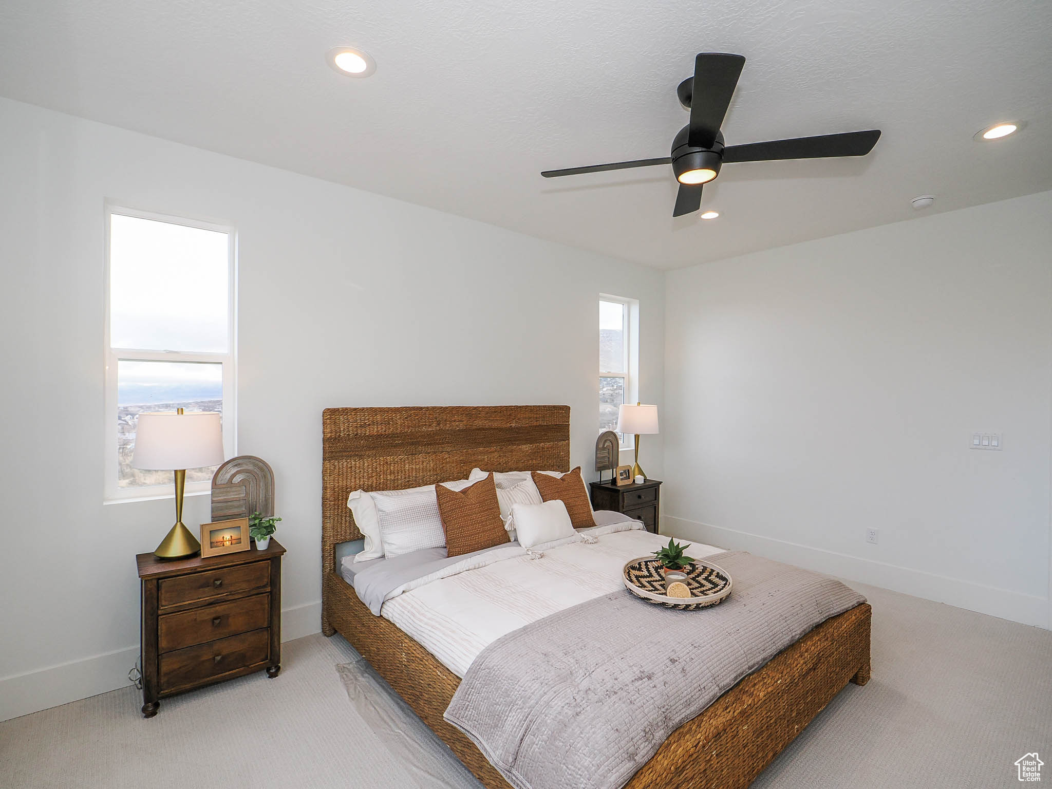 Carpeted bedroom featuring ceiling fan