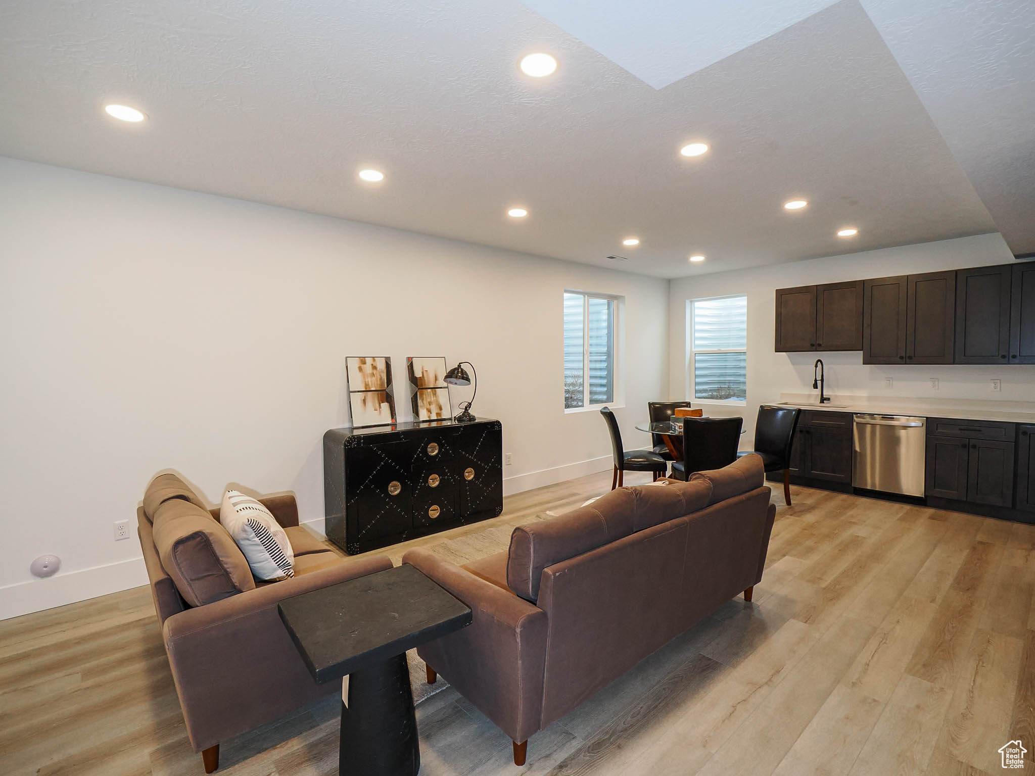 Living room featuring sink and light hardwood / wood-style floors