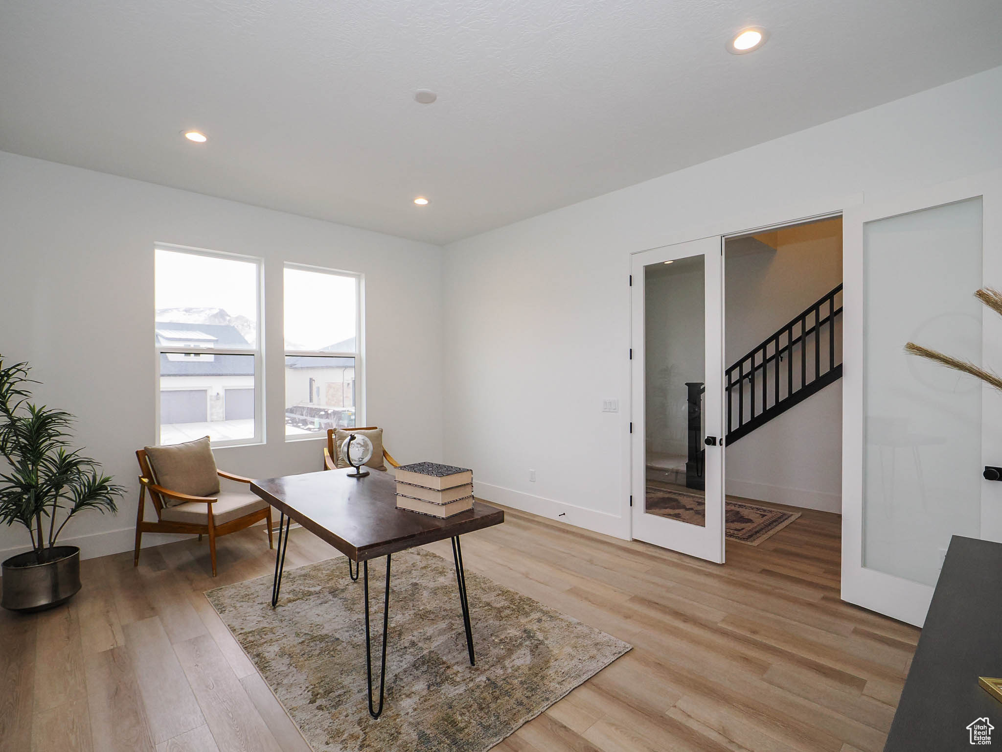 Sitting room with light hardwood / wood-style flooring