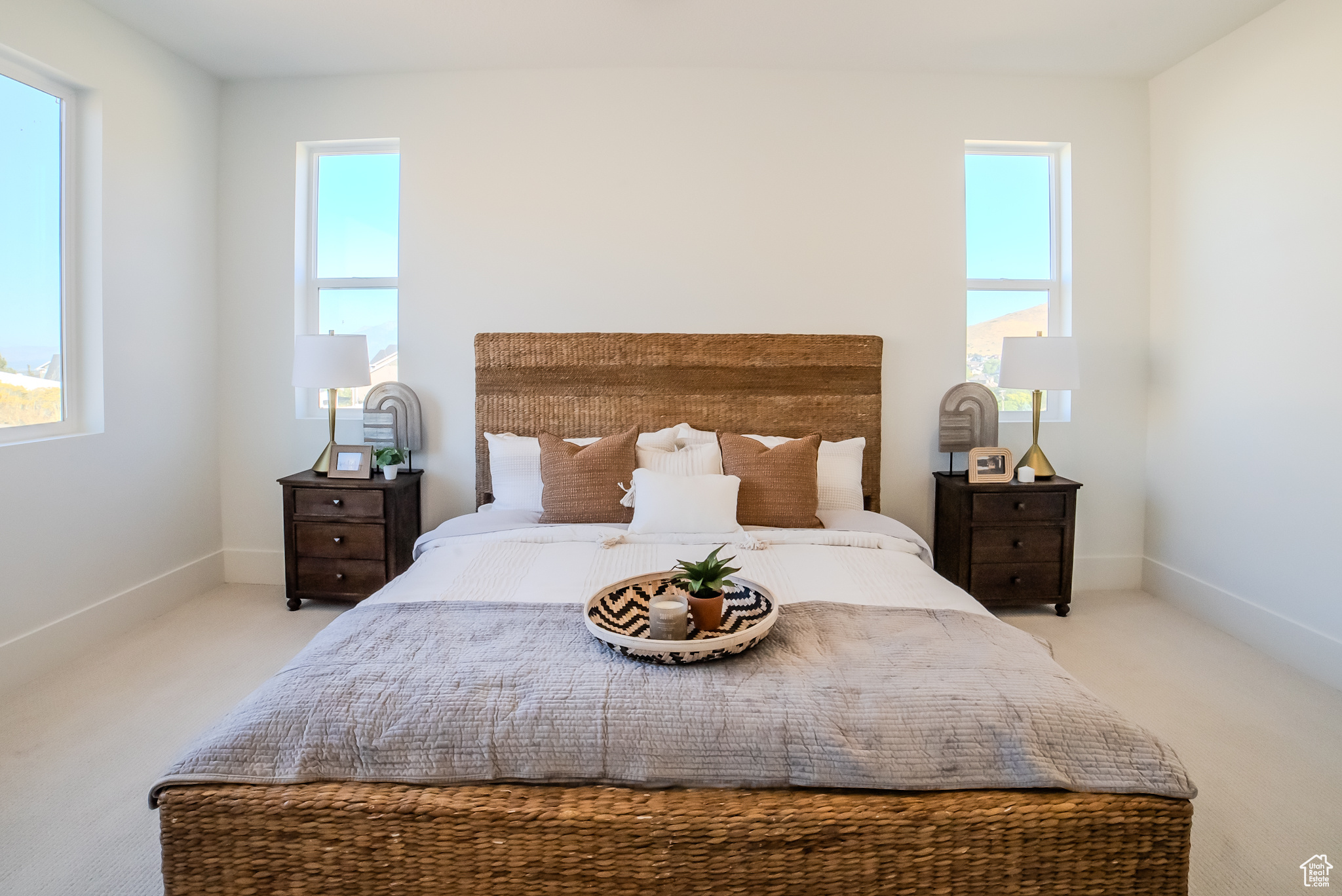 Carpeted bedroom with multiple windows