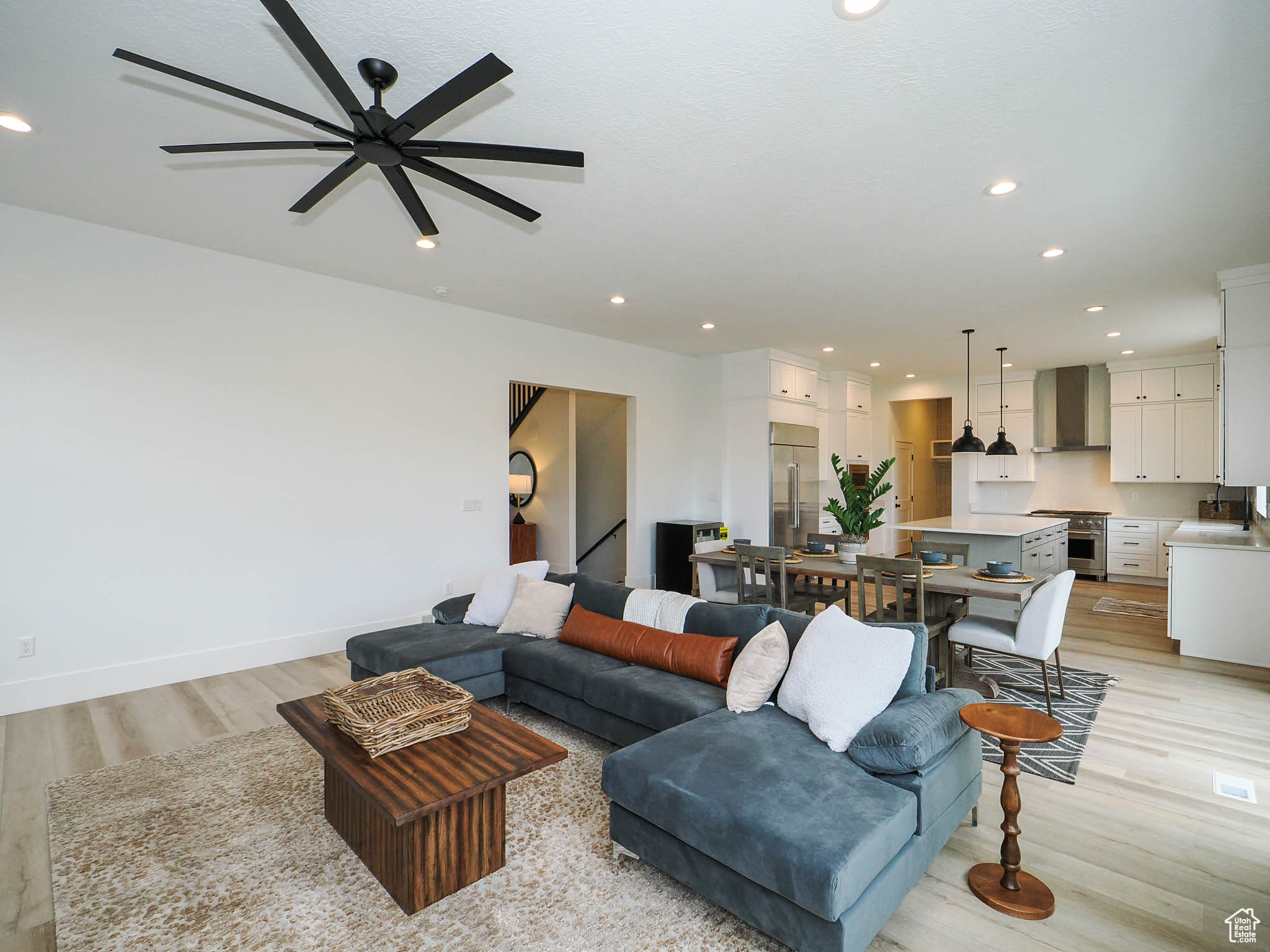 Living room with sink, light hardwood / wood-style floors, and ceiling fan