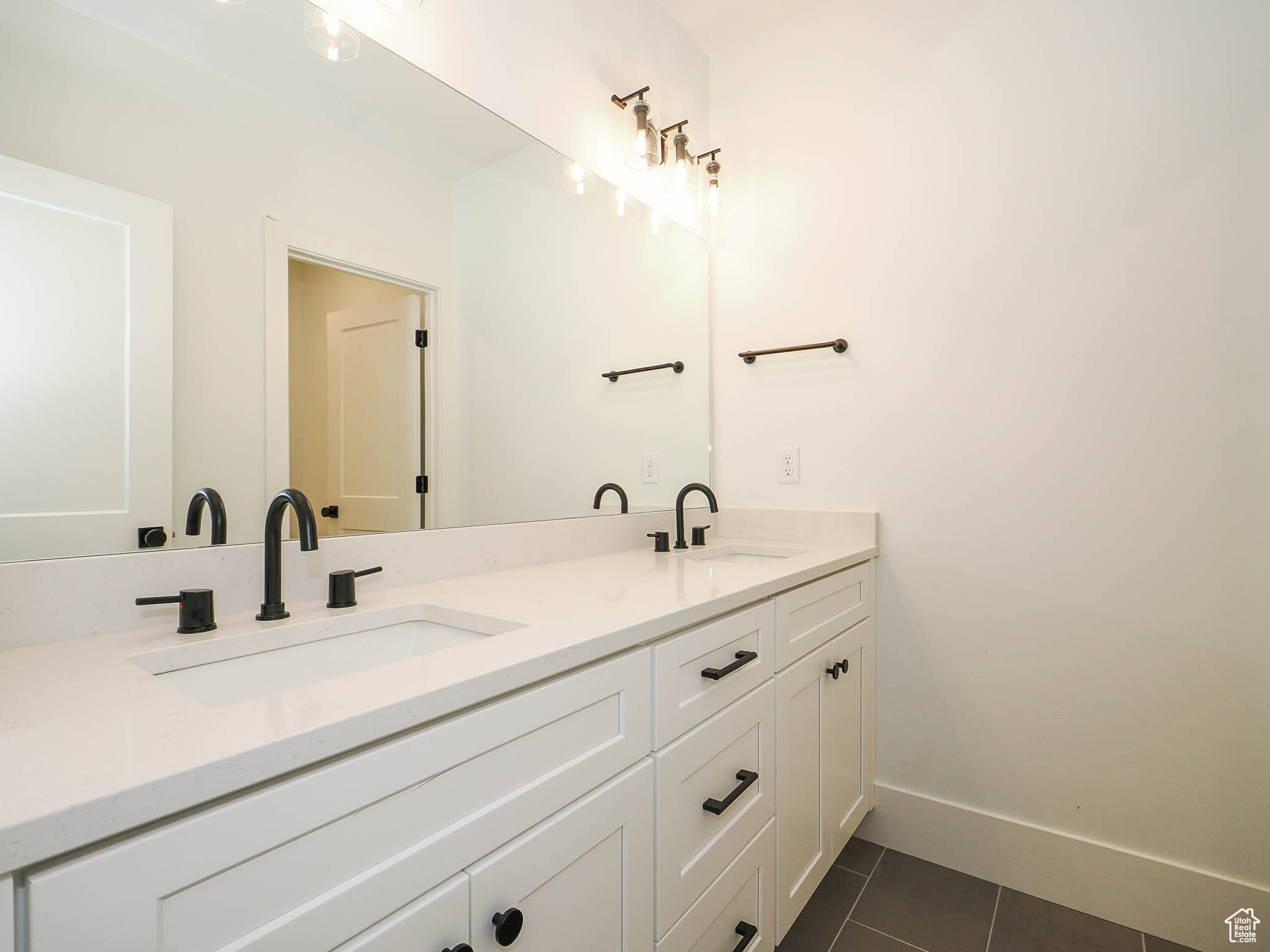 Bathroom with double sink vanity and tile flooring