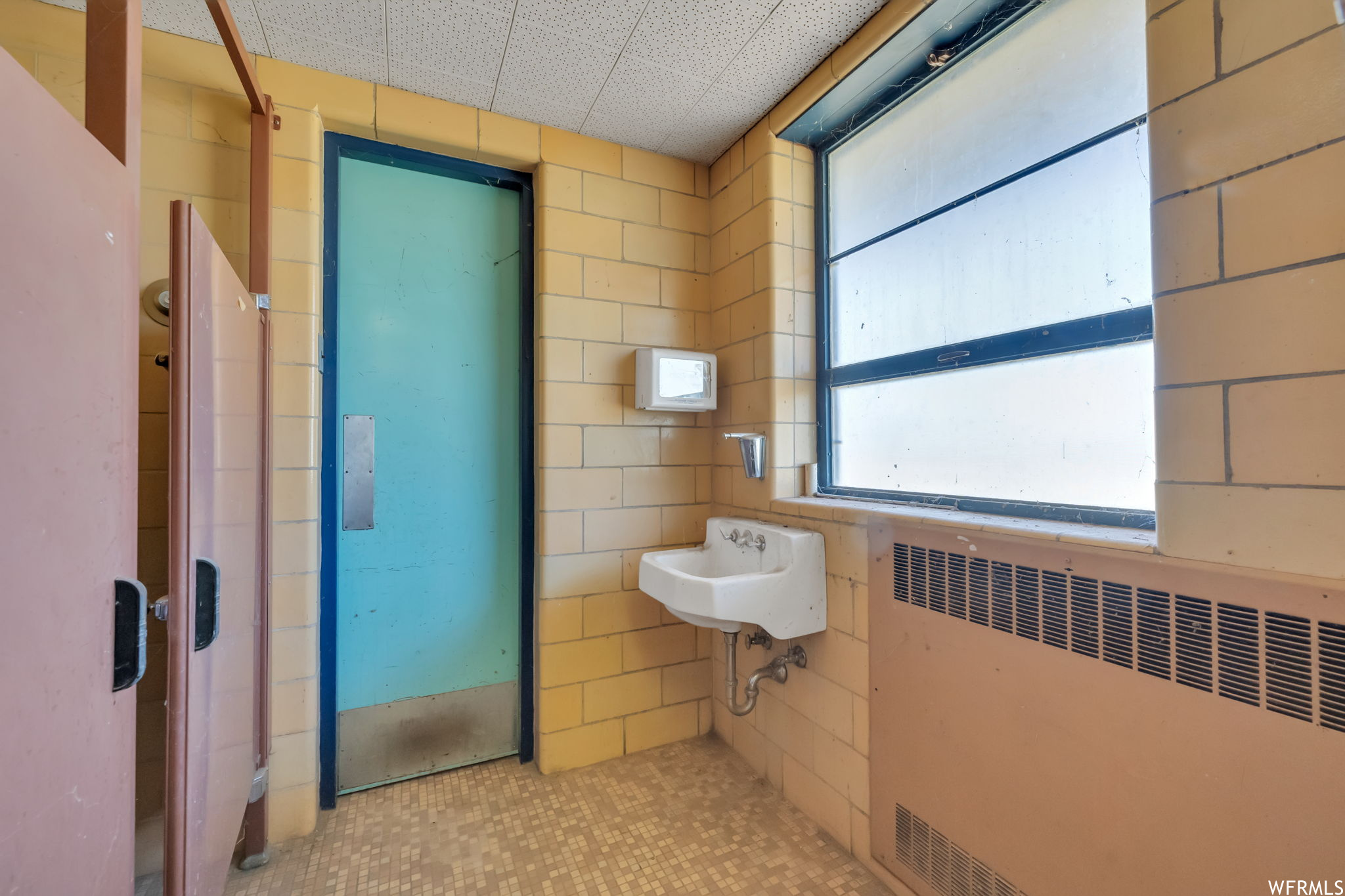 Bathroom with sink and radiator heating unit, located in the annex