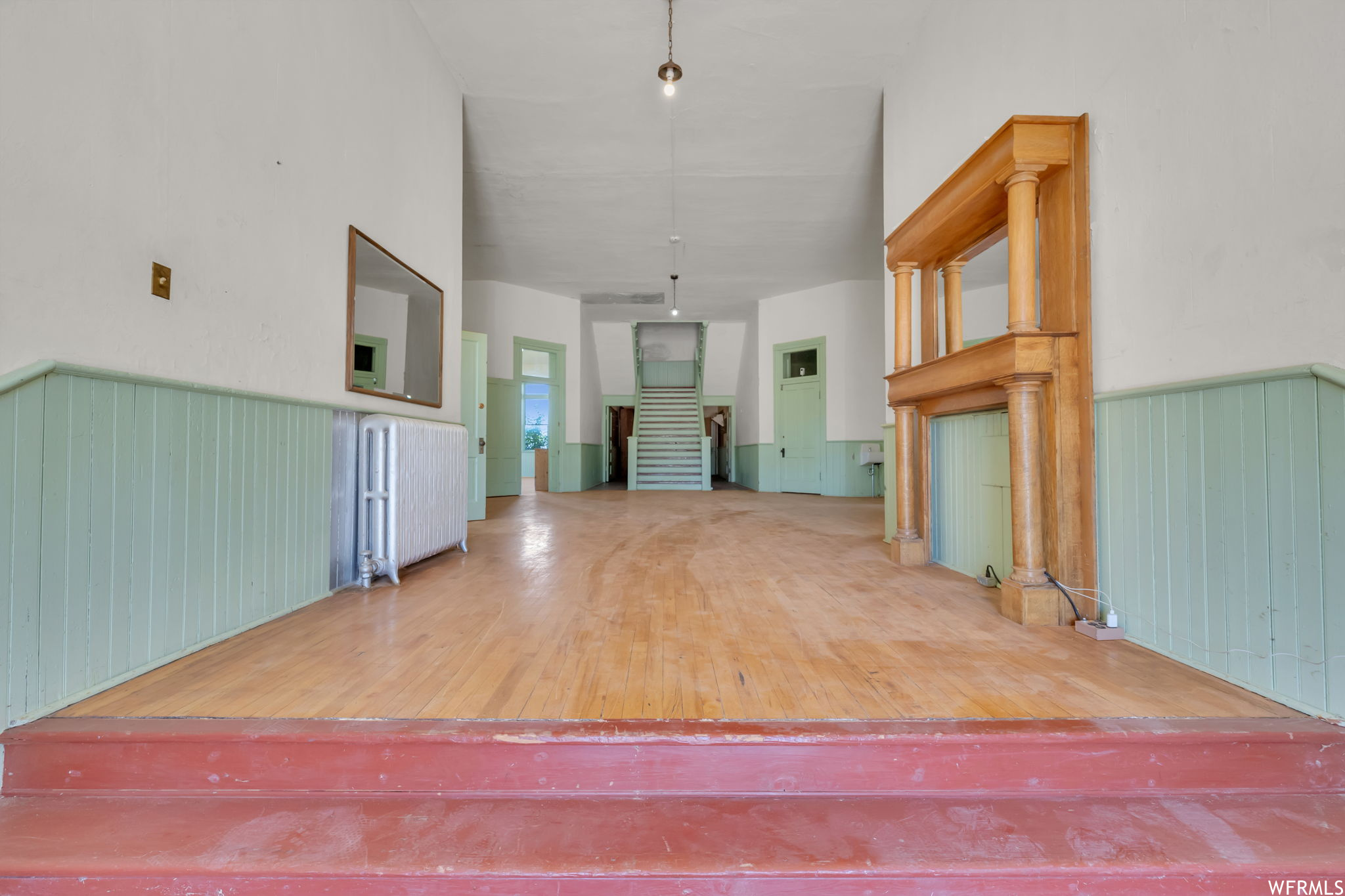 View of hardwood floor in entry. Mantel excluded.