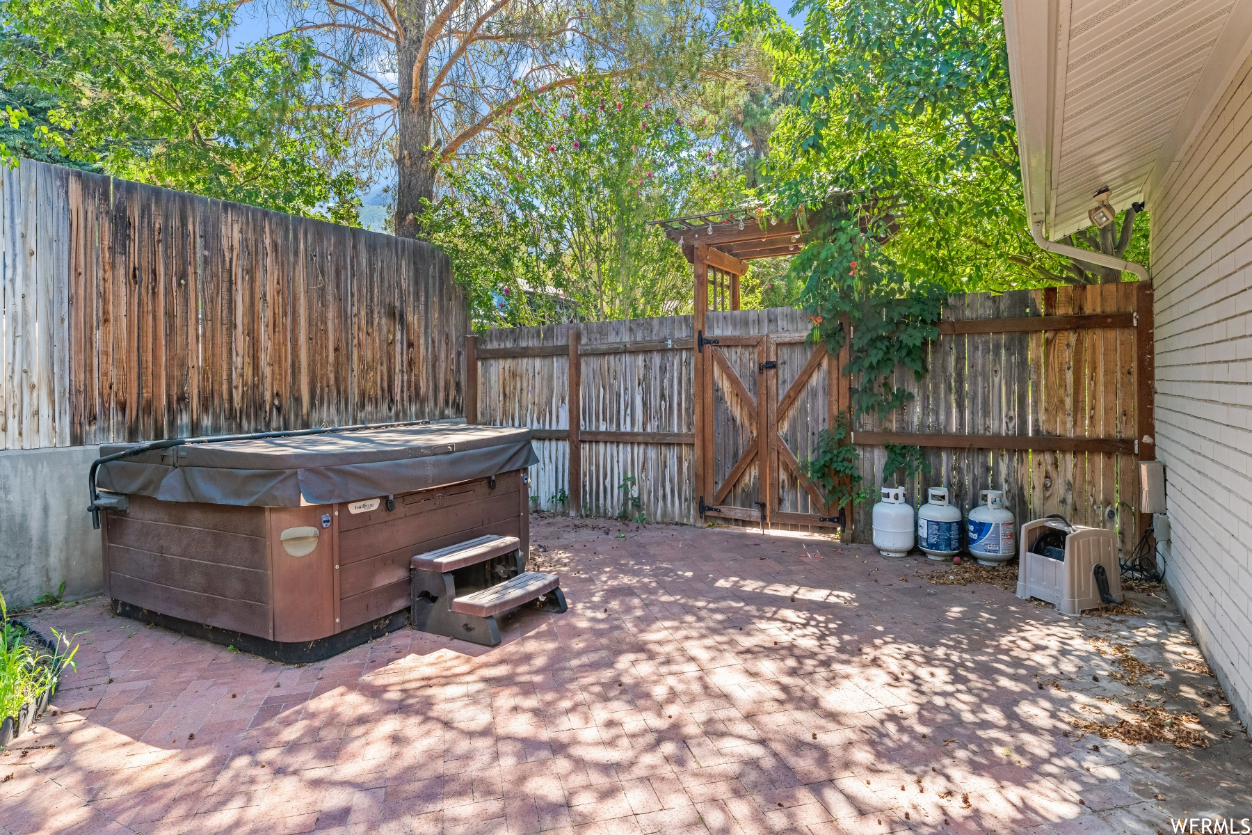 View of patio featuring hot tub