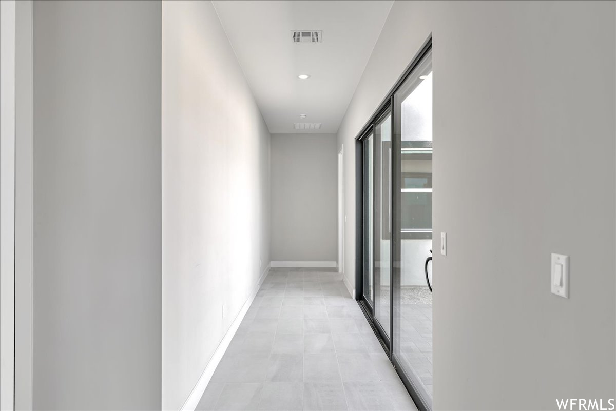 Hallway with light tile floors