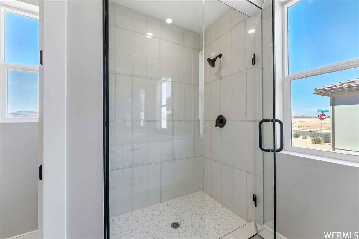 Bathroom featuring a shower with door