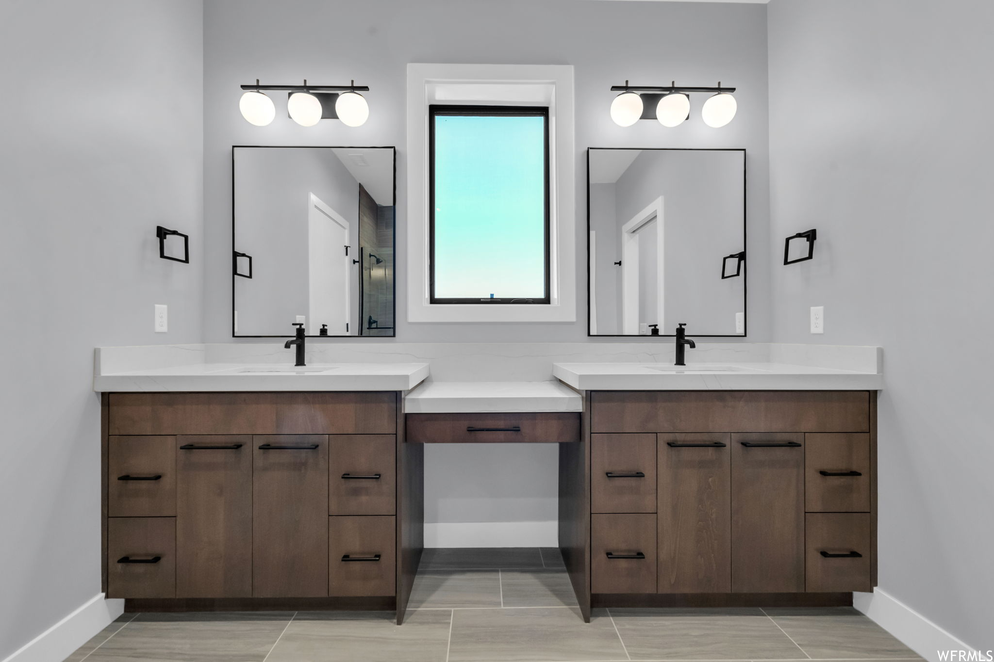Bathroom with tile flooring and double sink vanity