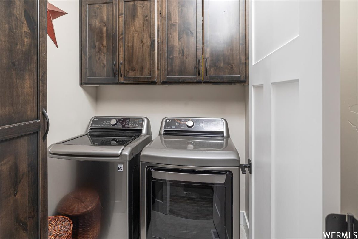 Laundry area with cabinets and washer and dryer