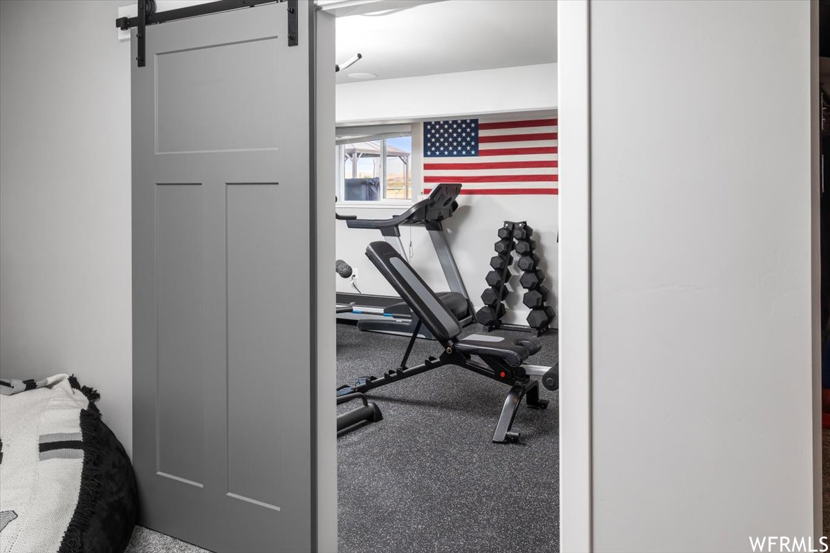 Workout room featuring a barn door