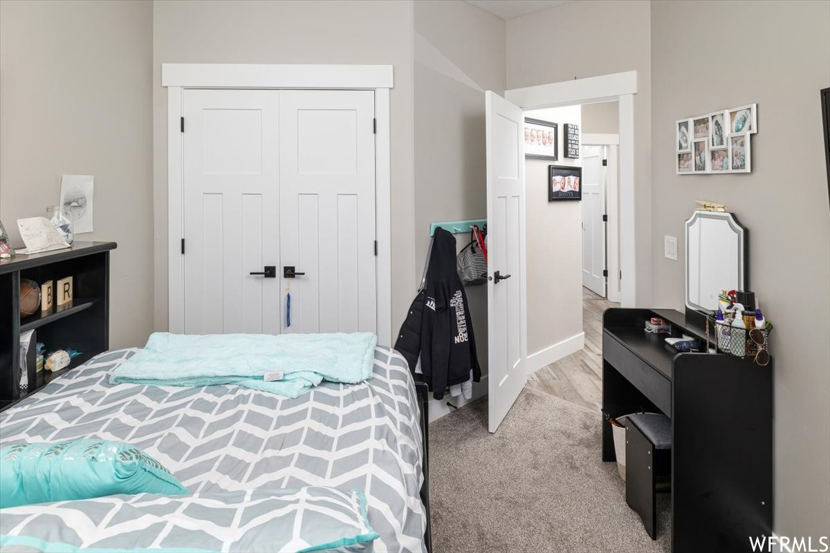 Bedroom featuring a closet and light carpet