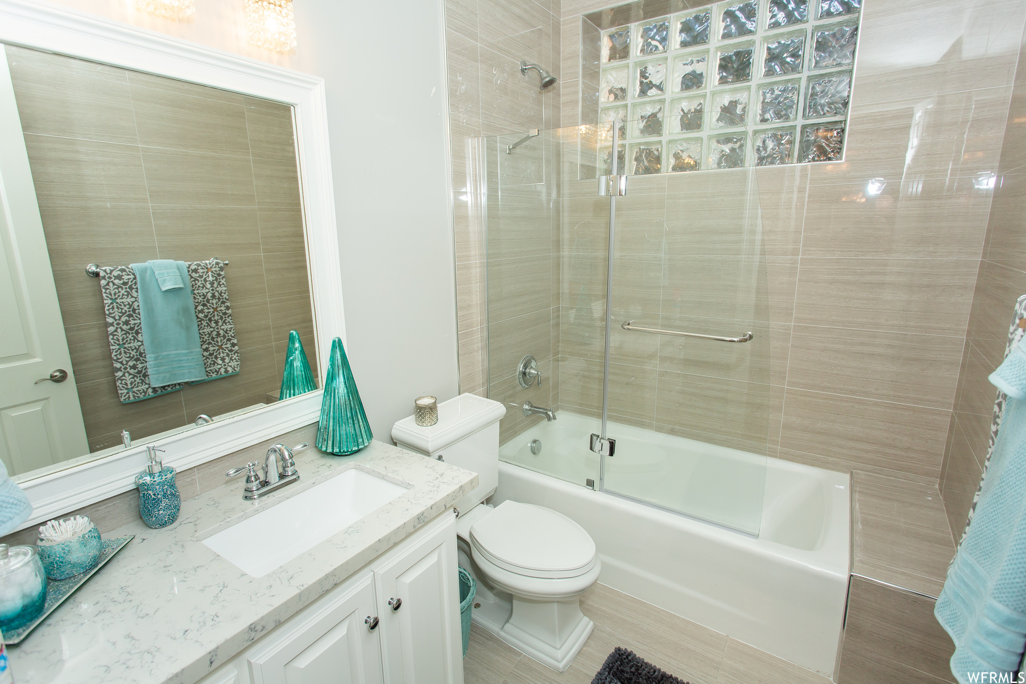 Full bathroom featuring enclosed tub / shower combo and oversized vanity