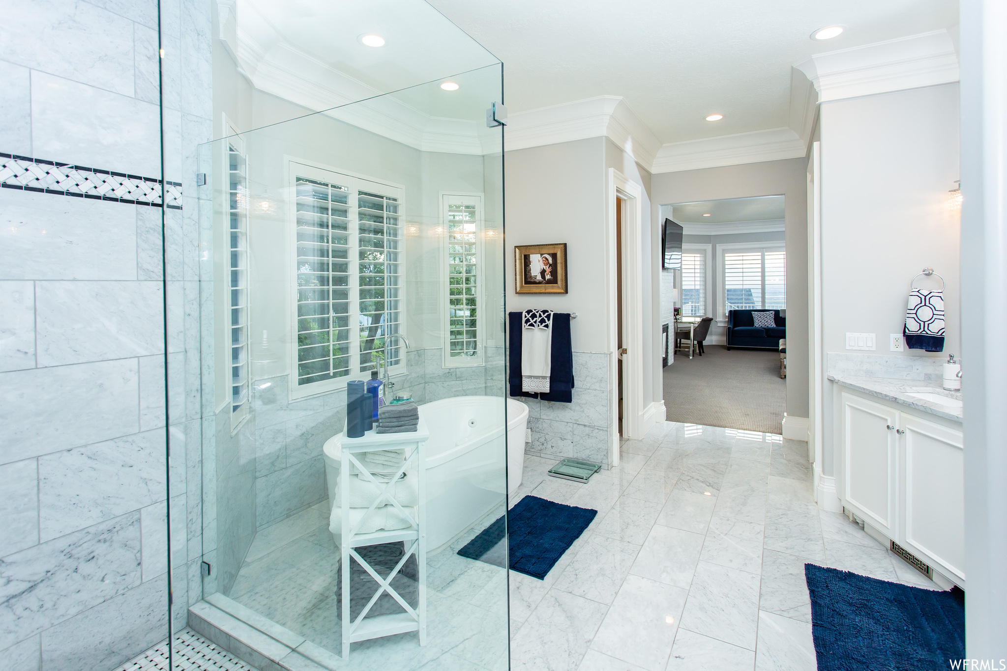 The master bathroom has marble floors, custom cabinets, soaker garden tub and separate Euro shower.