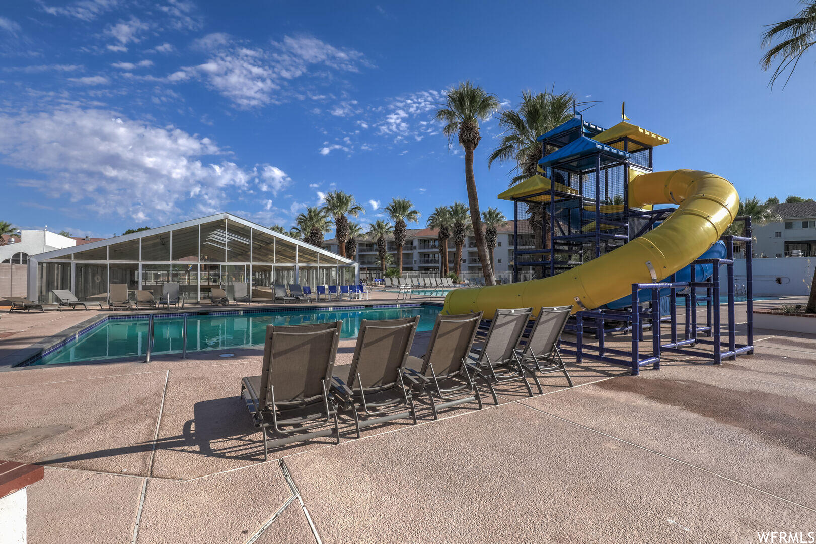 View of swimming pool with a lanai and a patio area