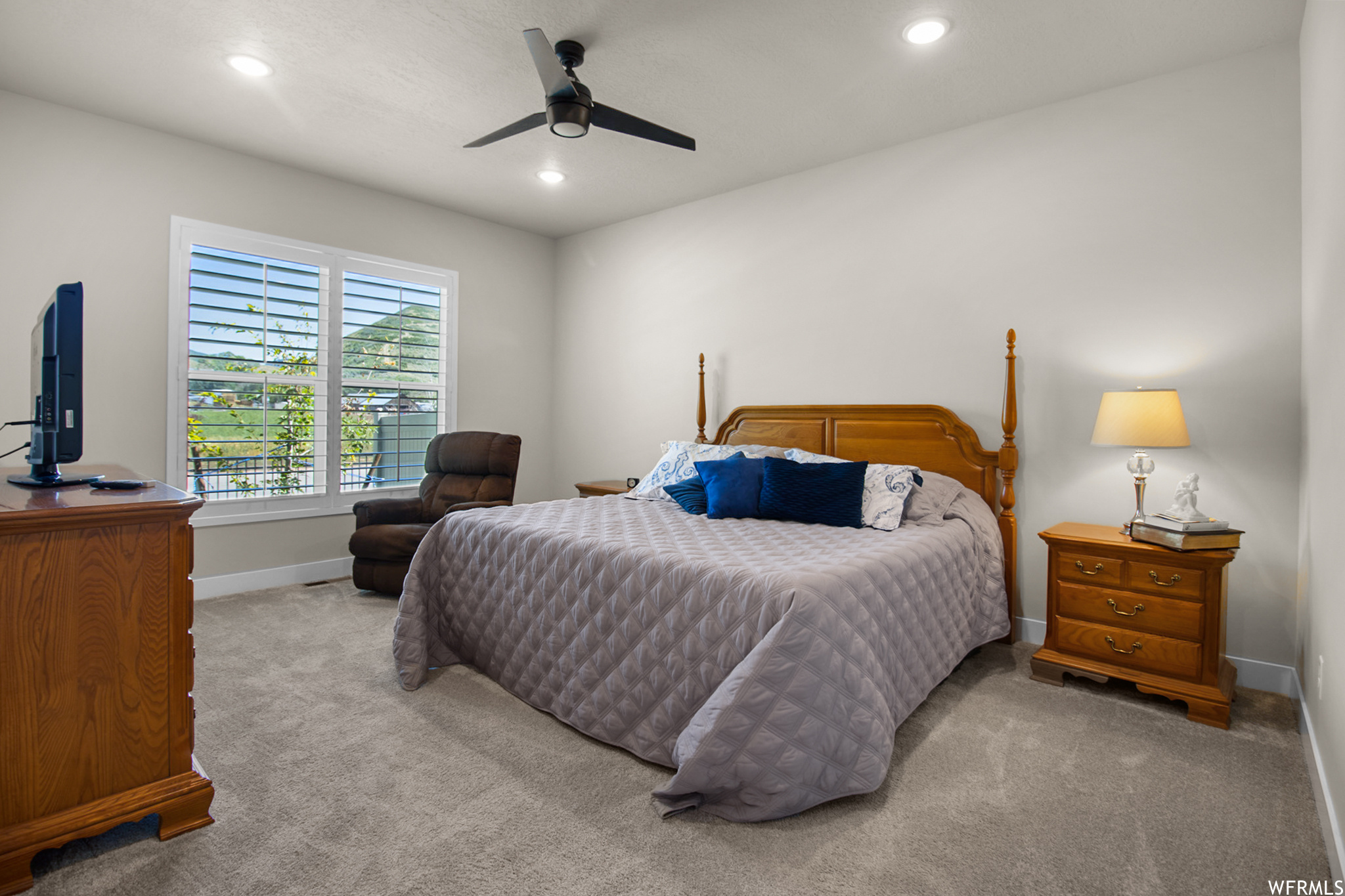 Carpeted bedroom with ceiling fan