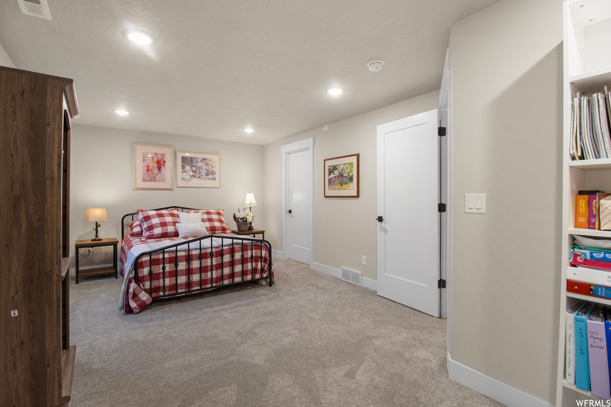 Bedroom featuring light carpet