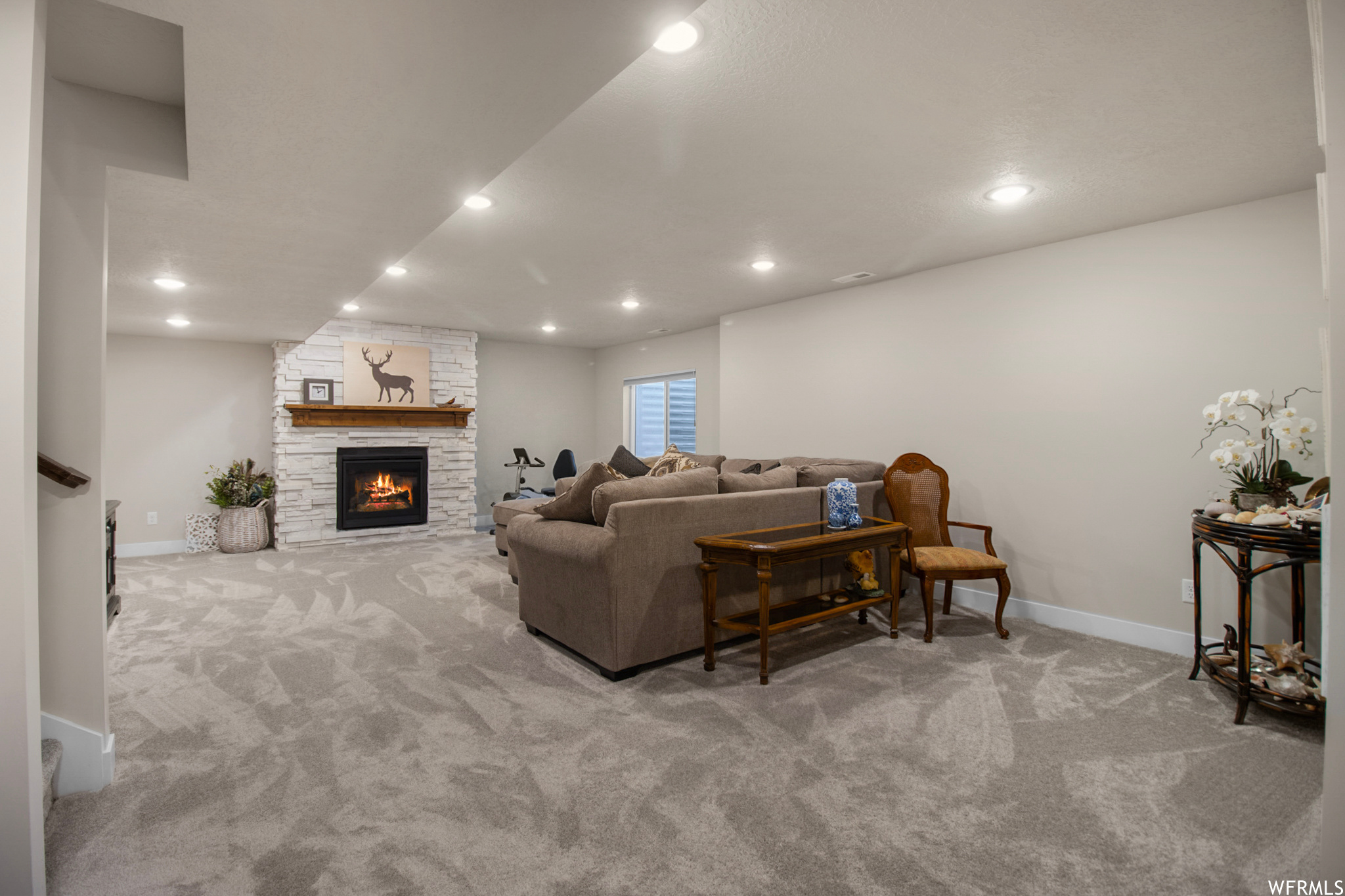 Carpeted living room featuring a fireplace