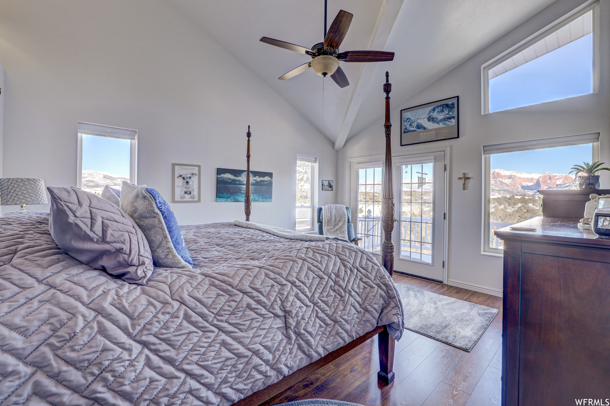 Bedroom featuring multiple windows, access to outside, light hardwood / wood-style flooring, high vaulted ceiling, and ceiling fan