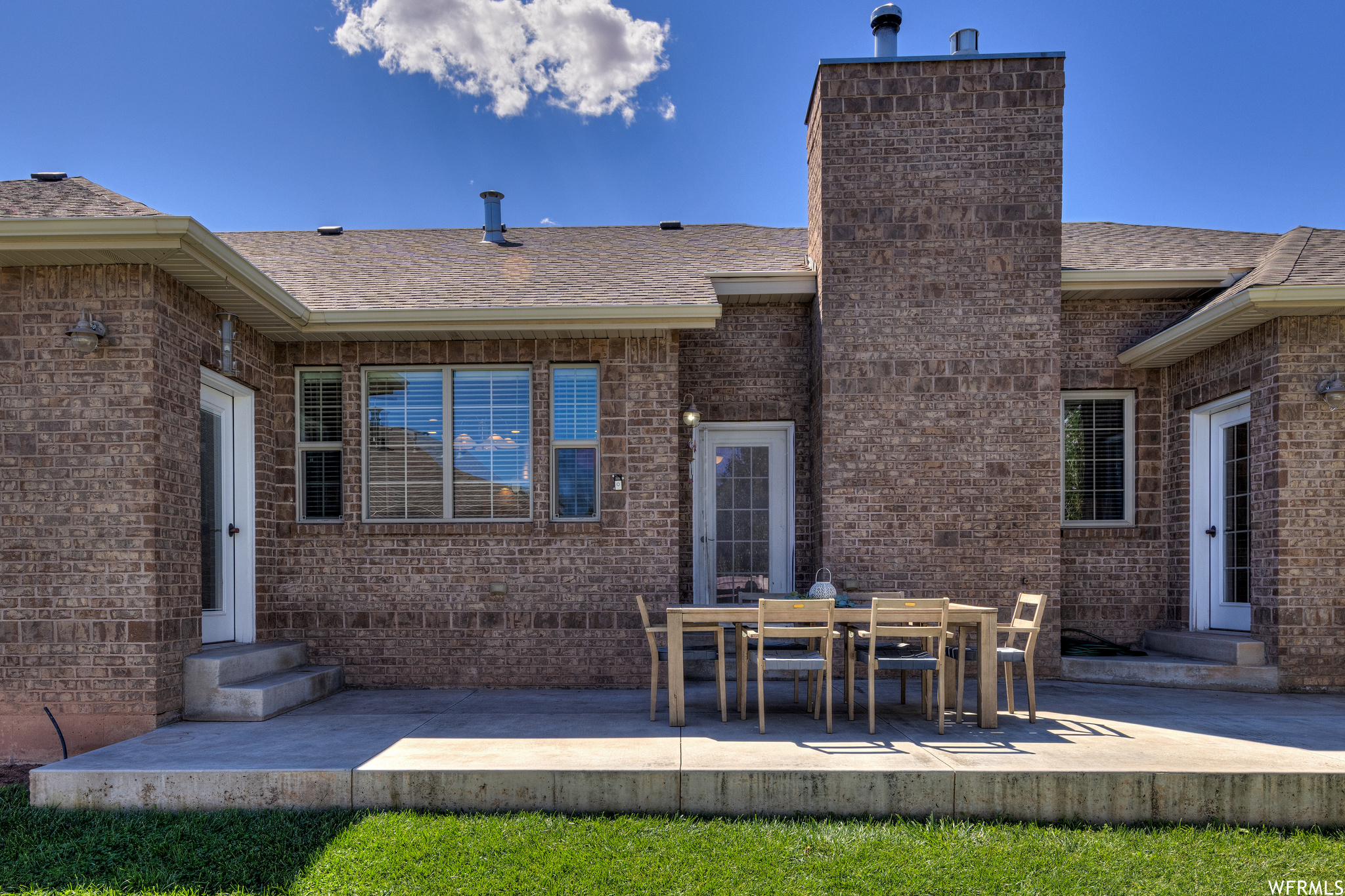 Back of property with a patio