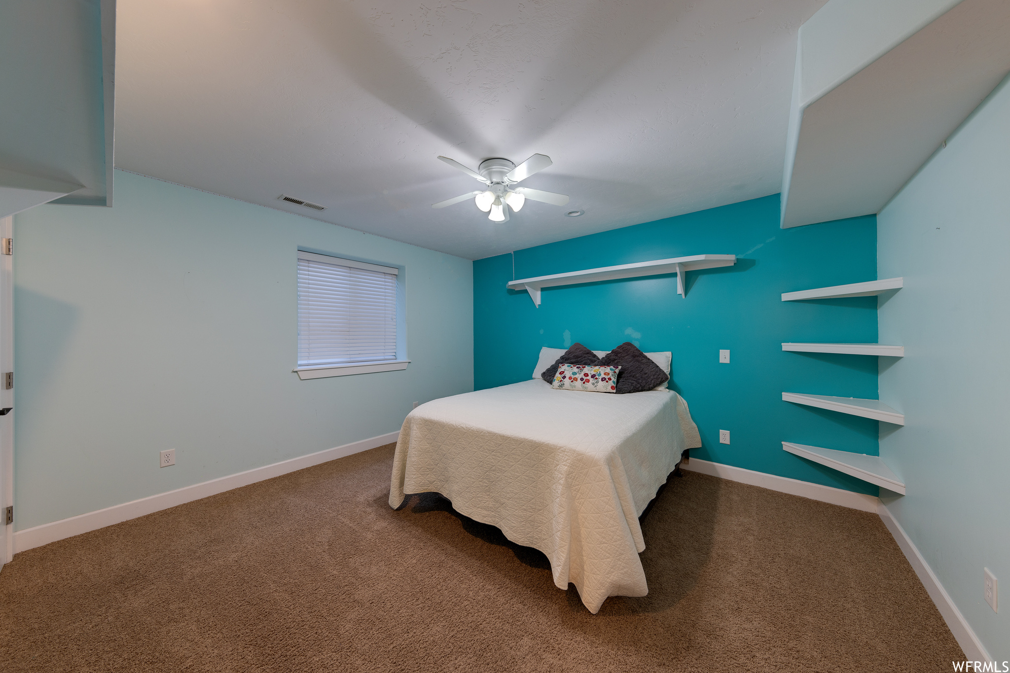 Bedroom with dark carpet and ceiling fan