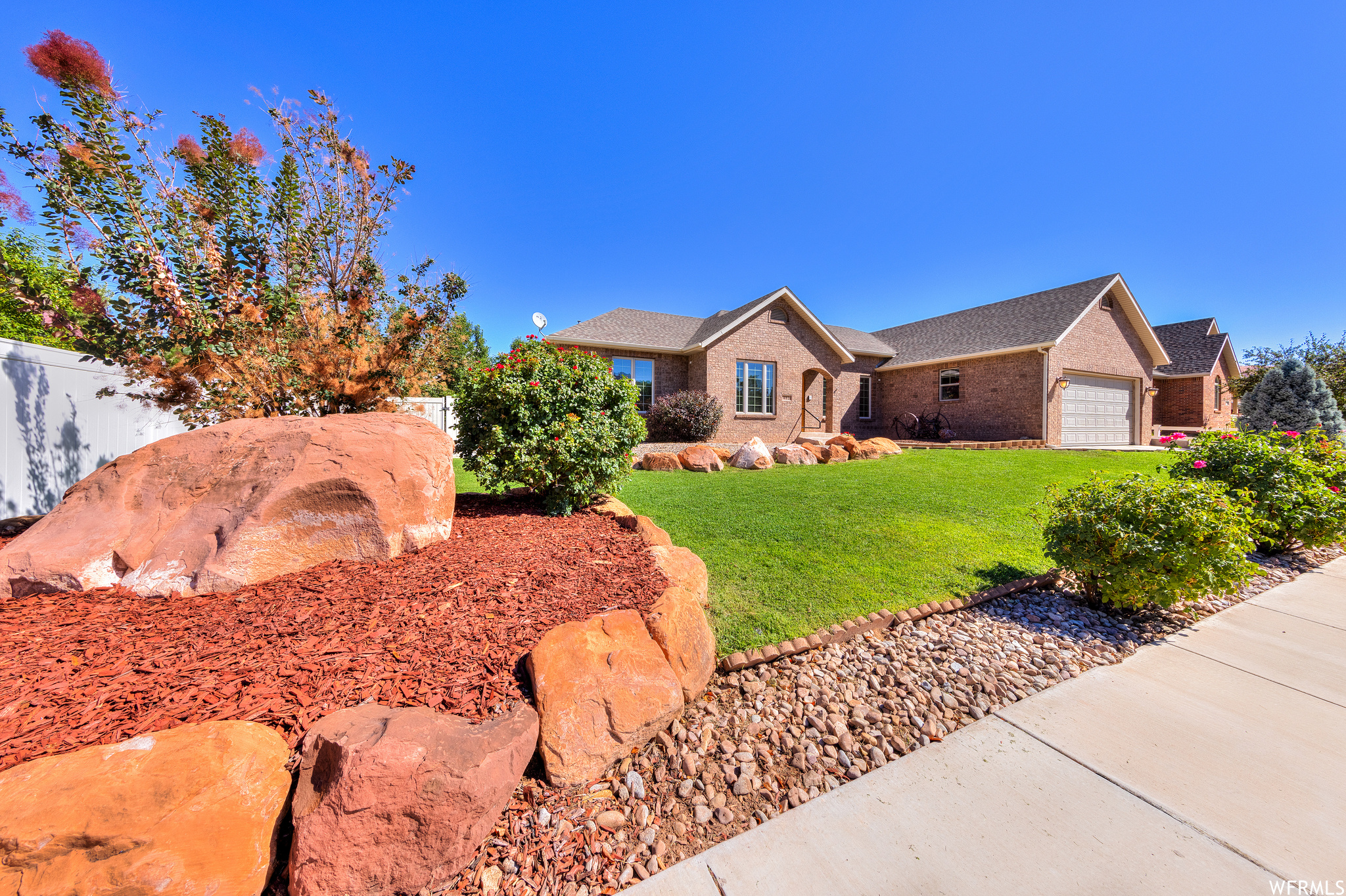 Ranch-style home featuring a front yard