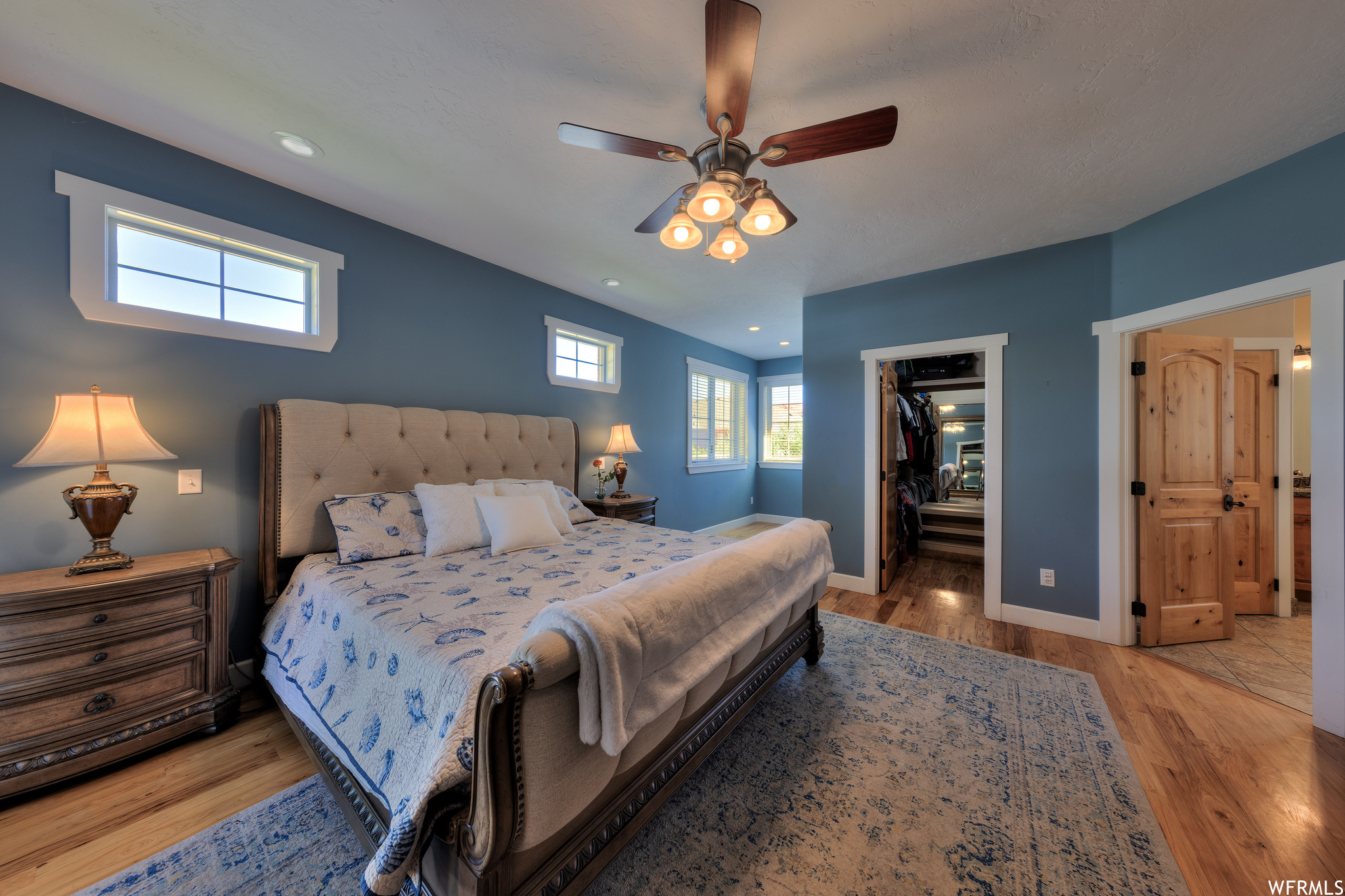 Hardwood floored bedroom featuring ceiling fan