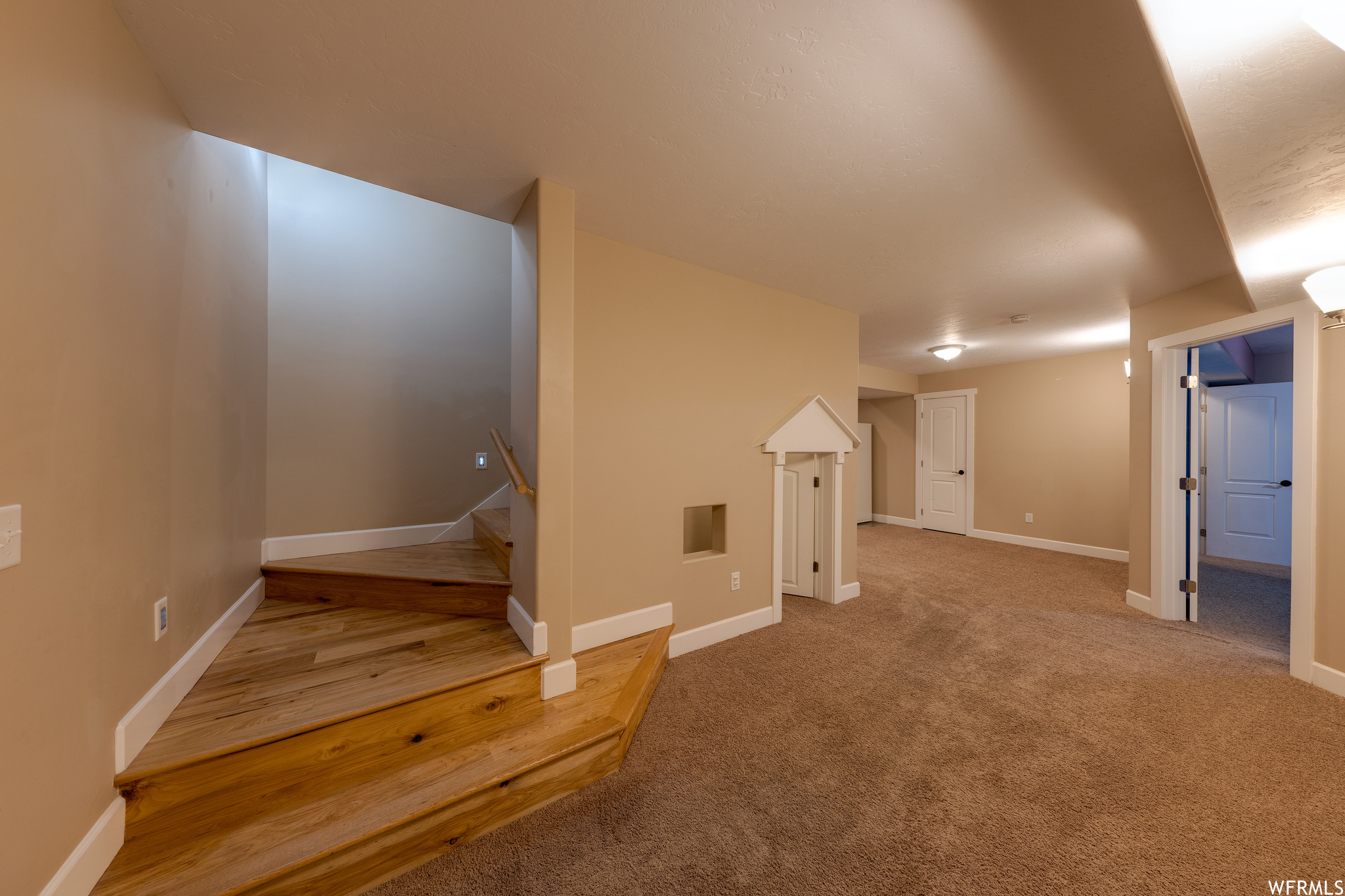 Stairway featuring light carpet