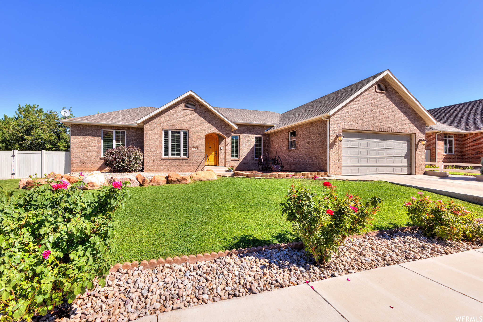 Single story home with garage and a front lawn