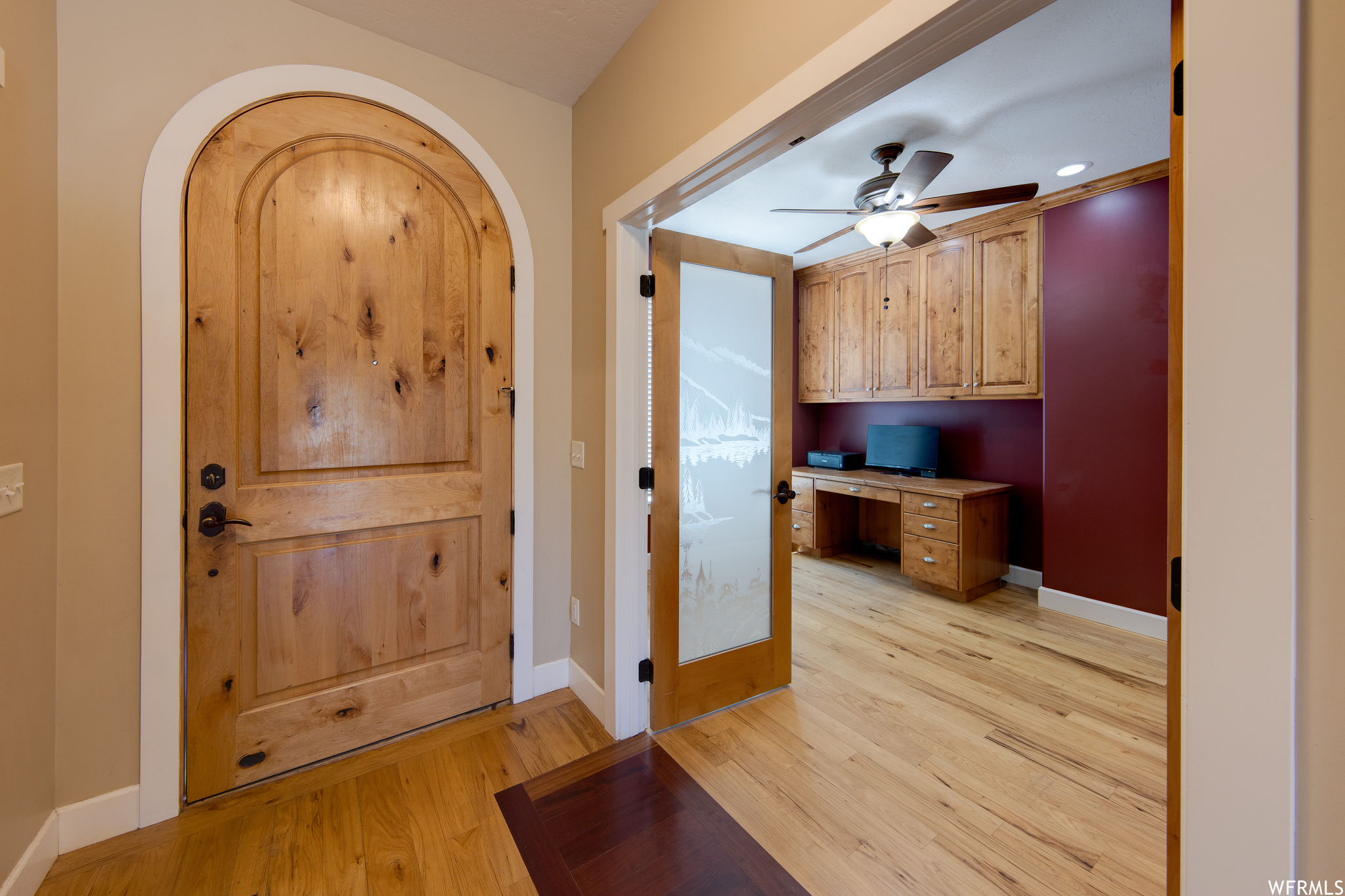 Hardwood floored entrance foyer featuring ceiling fan