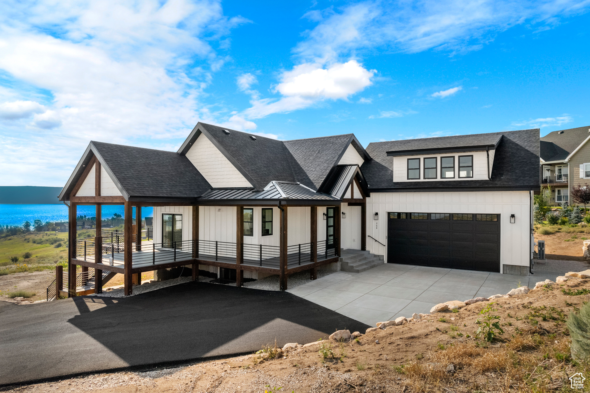 View of front of house with covered porch and a water view