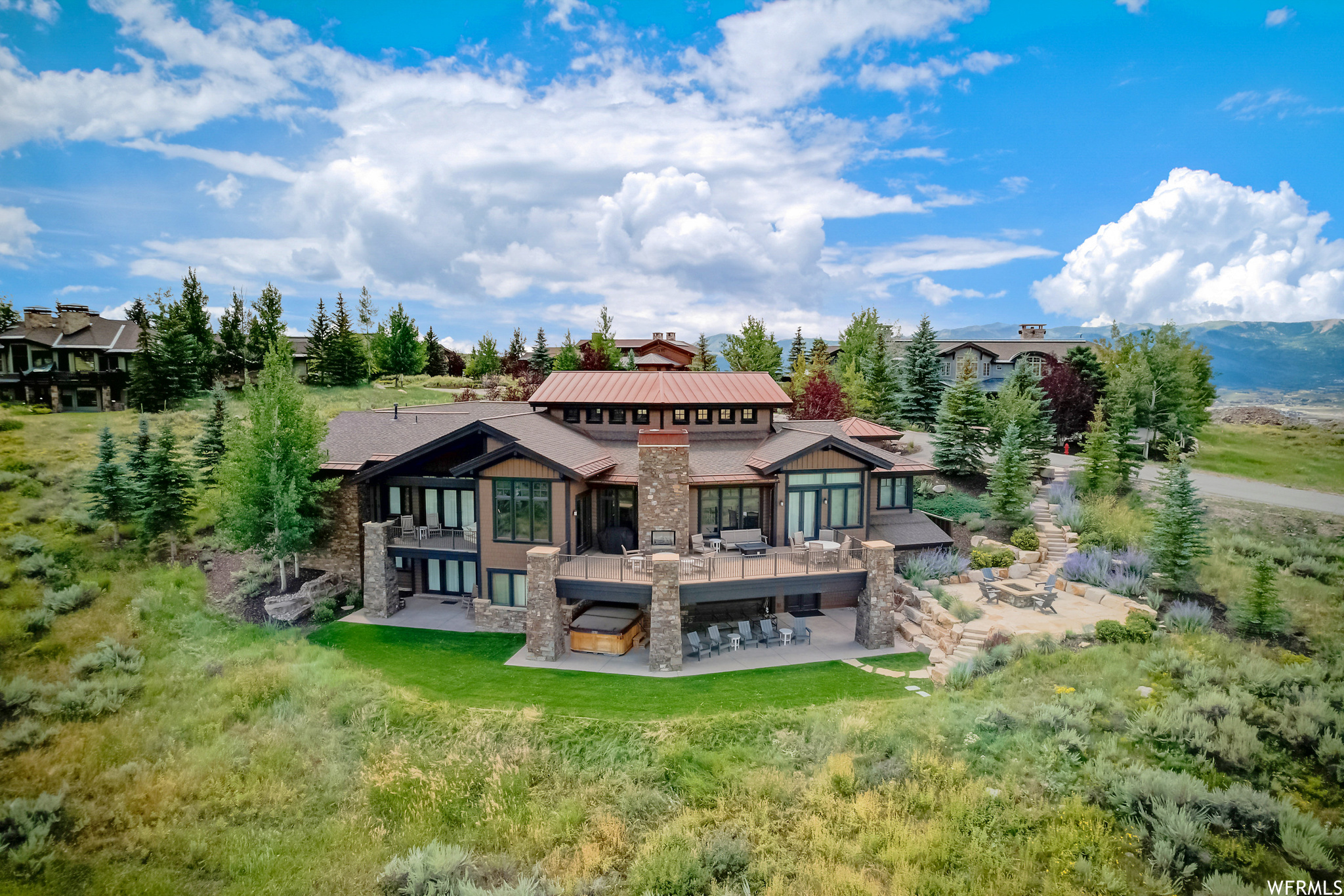 Drone view of property featuring a patio and 2 decks