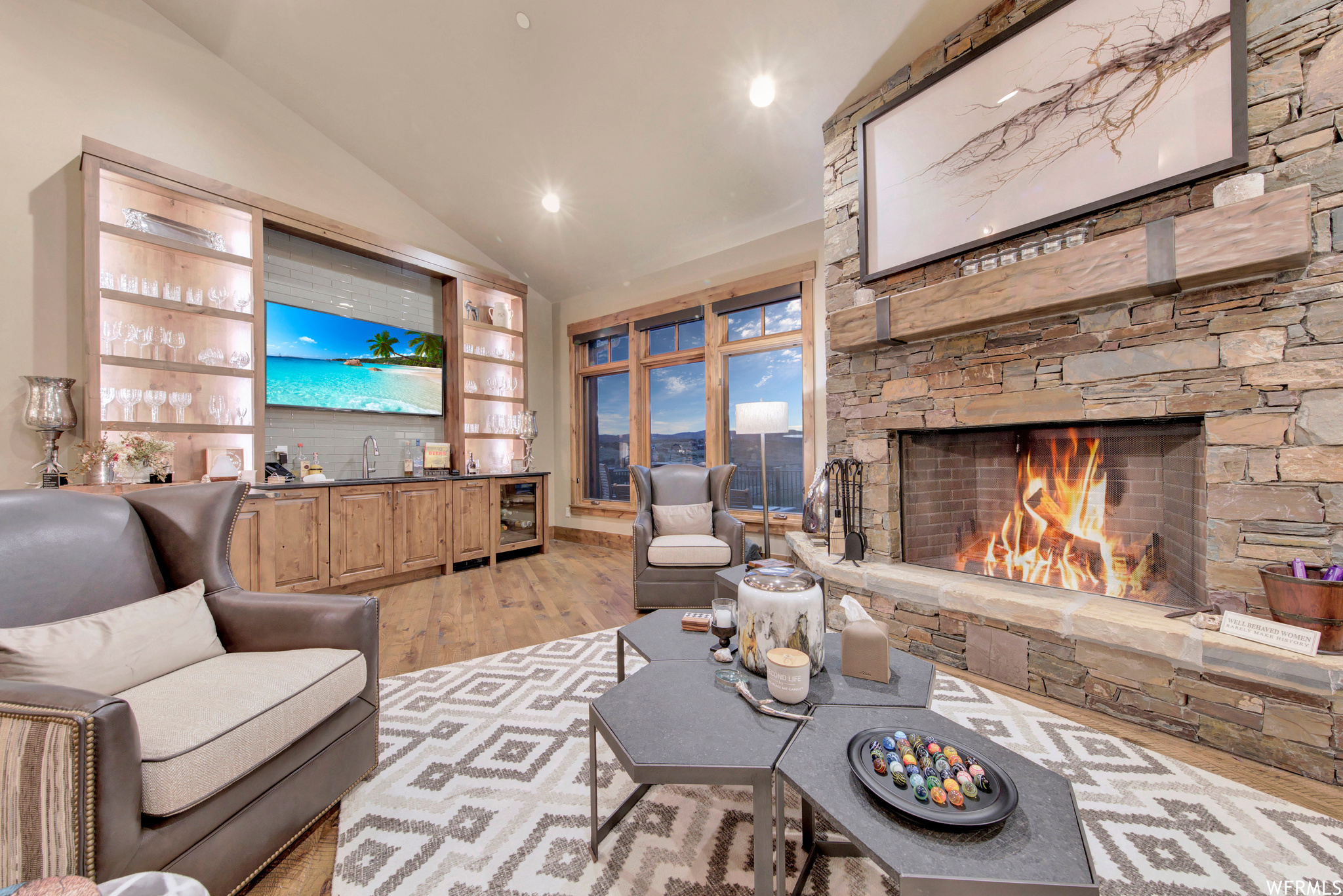 Hardwood floored living room area with a large fireplace, and wonderful bar for entertaining.