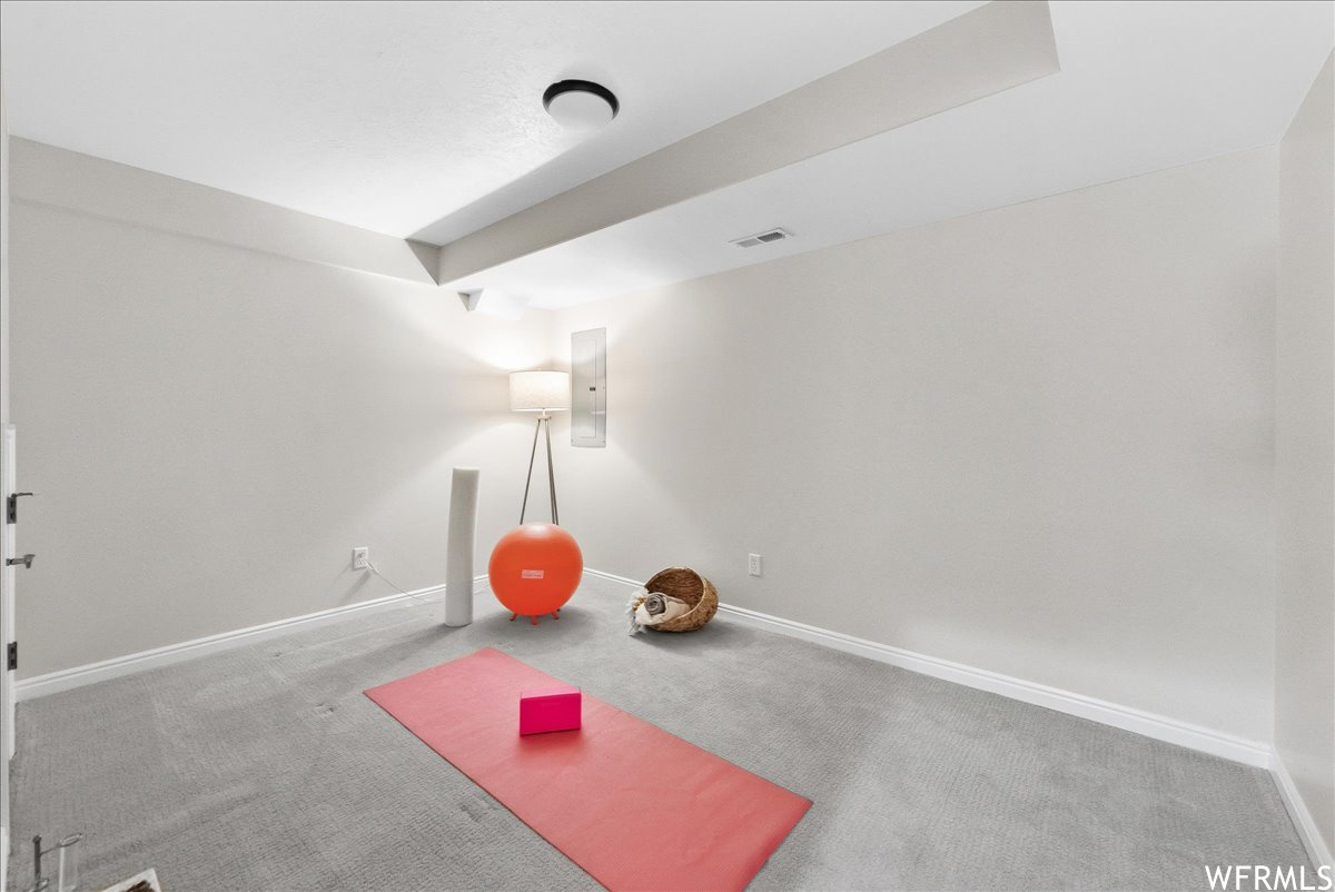 Workout room featuring light carpet