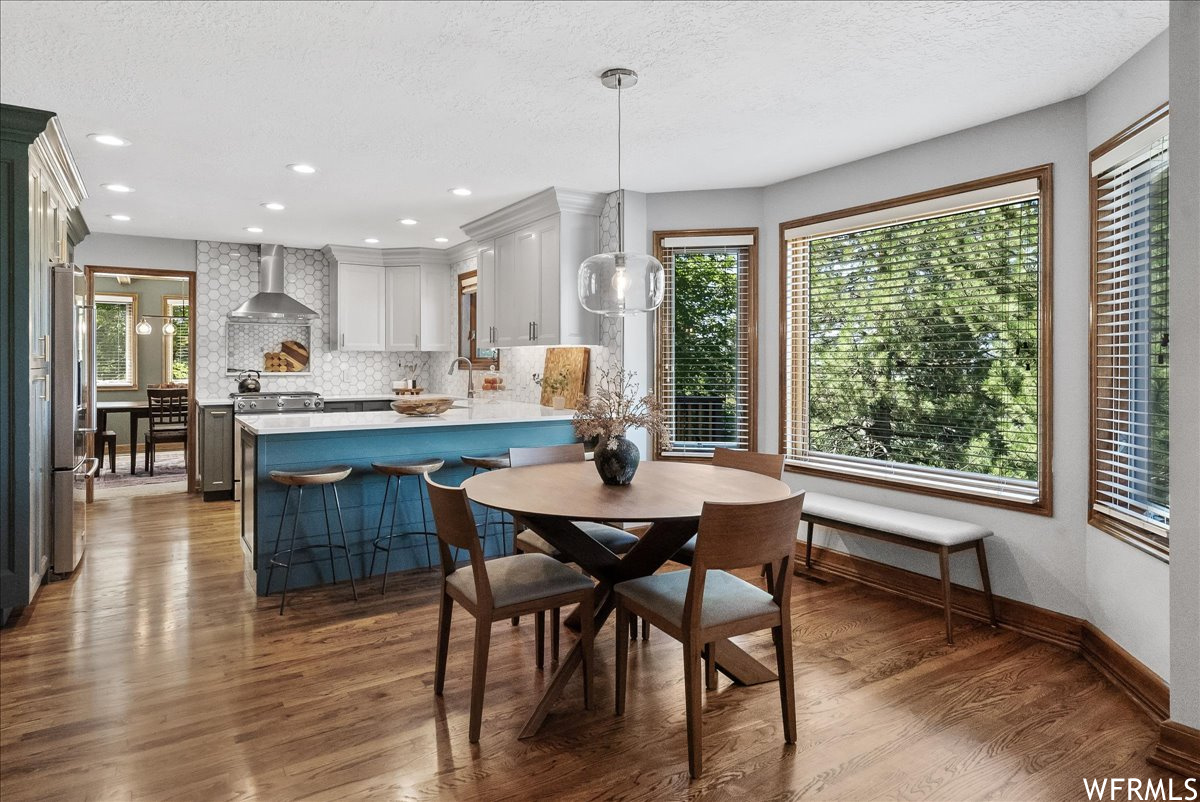 Dining area with wood-type flooring