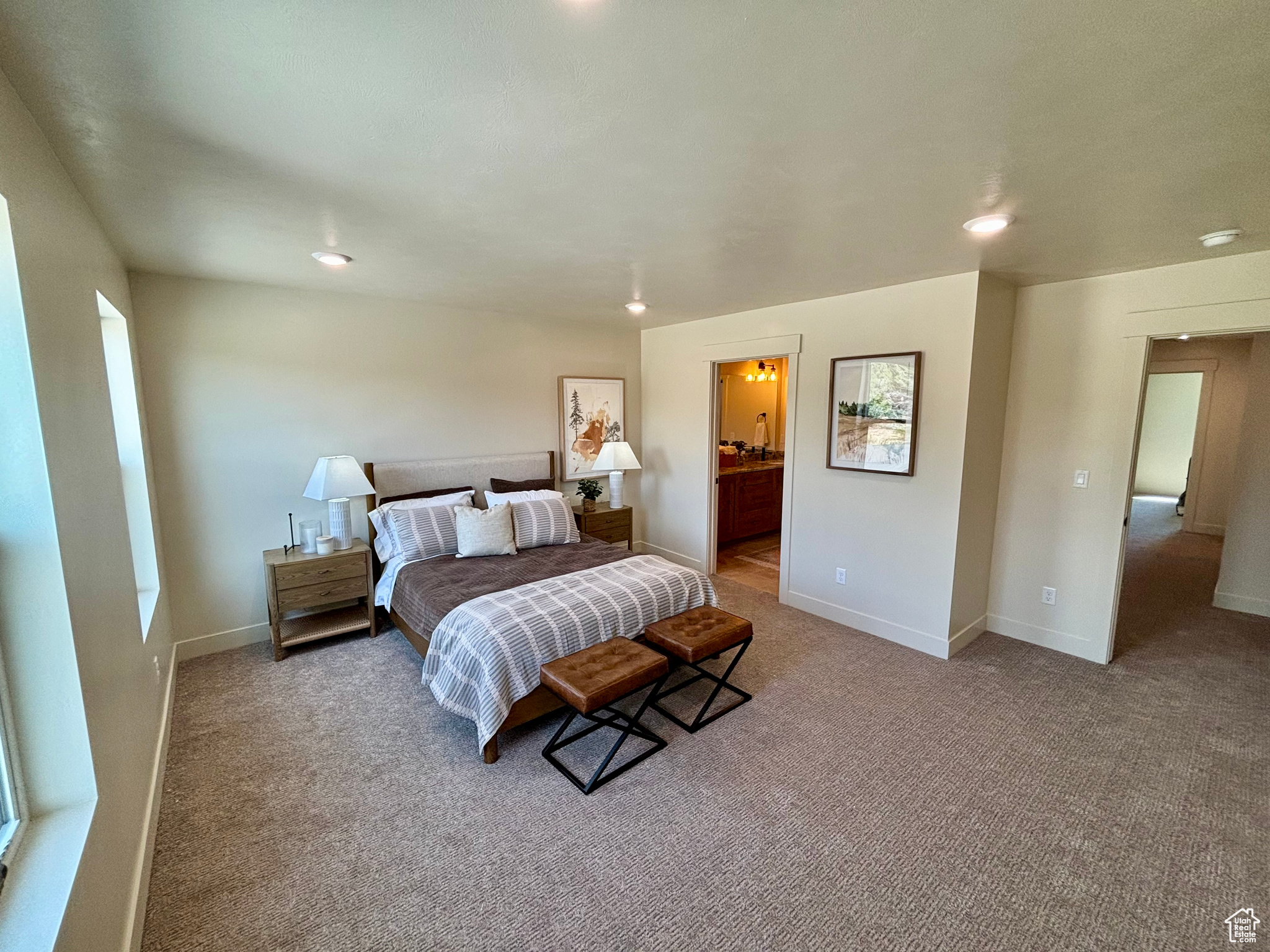 Carpeted bedroom featuring ensuite bathroom