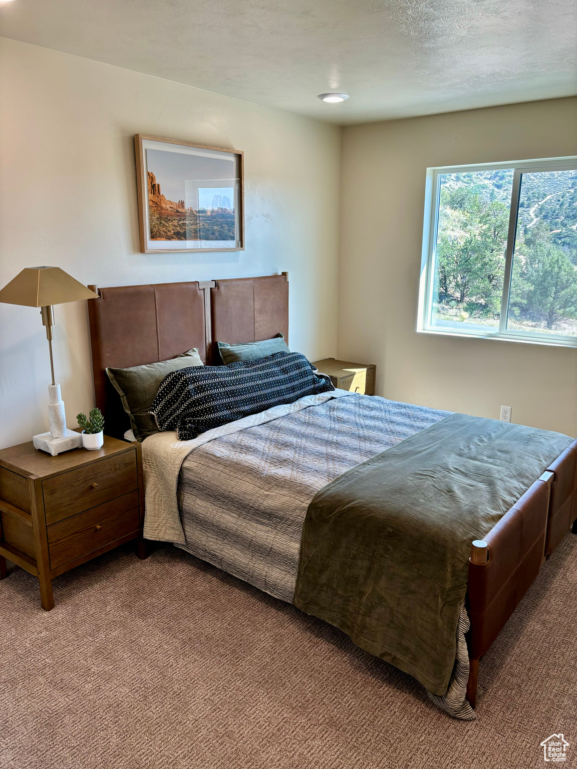 Carpeted bedroom featuring a textured ceiling