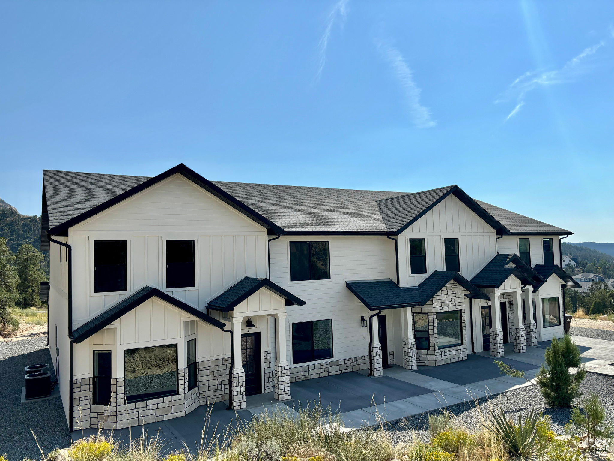 View of front of house featuring central AC