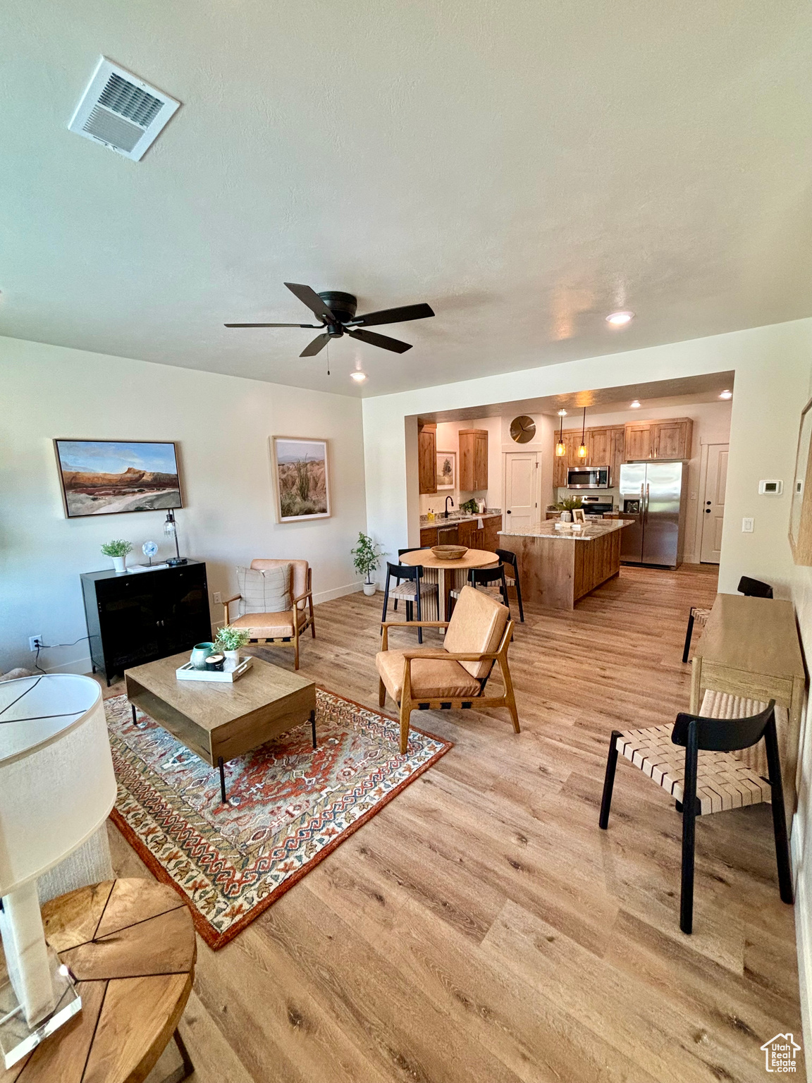 Living room featuring light hardwood / wood-style floors and ceiling fan