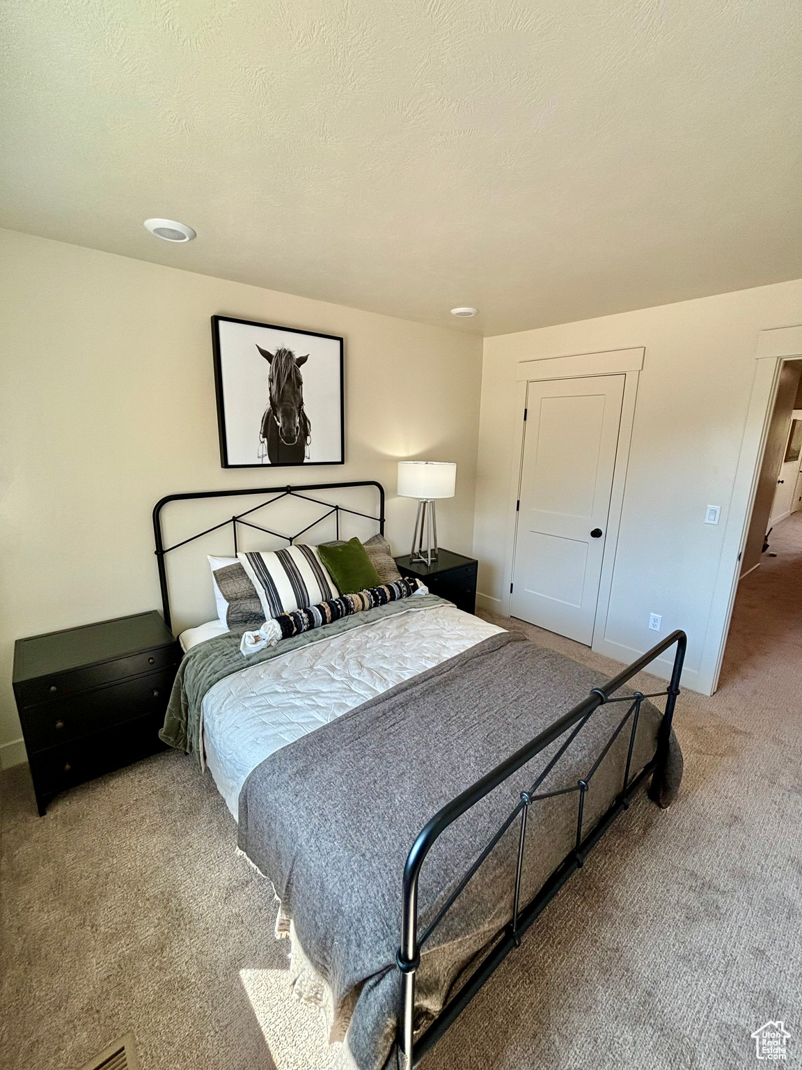 Bedroom featuring carpet floors and a textured ceiling