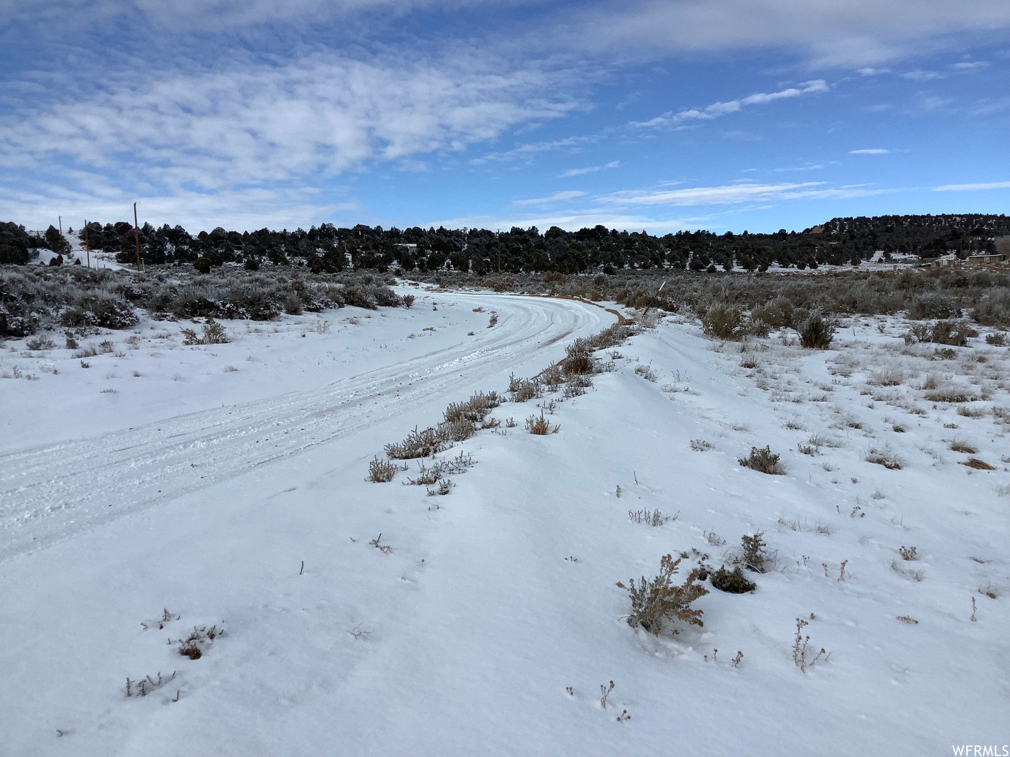 View of snow covered land featuring a water view