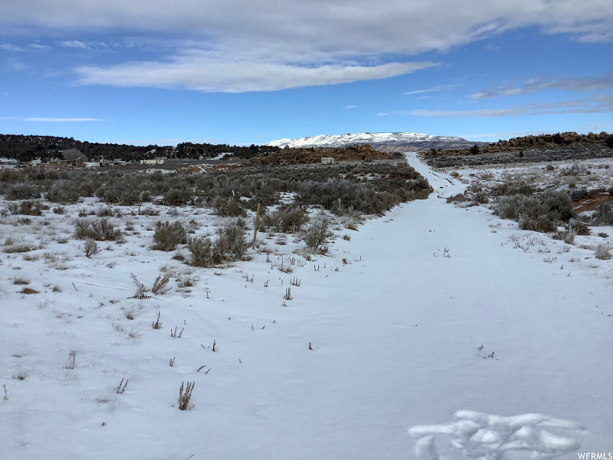 View of snow covered land featuring a water view