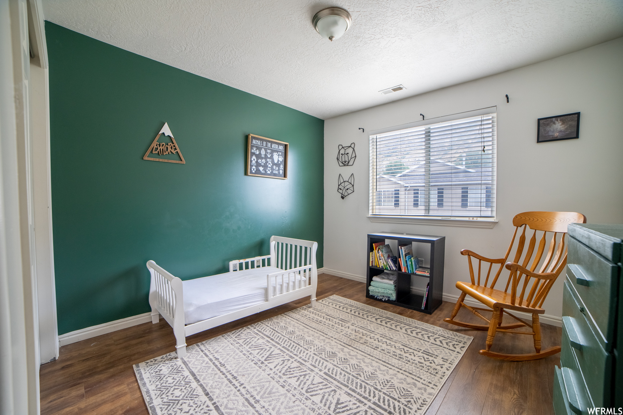 Bedroom featuring light hardwood flooring and a textured ceiling