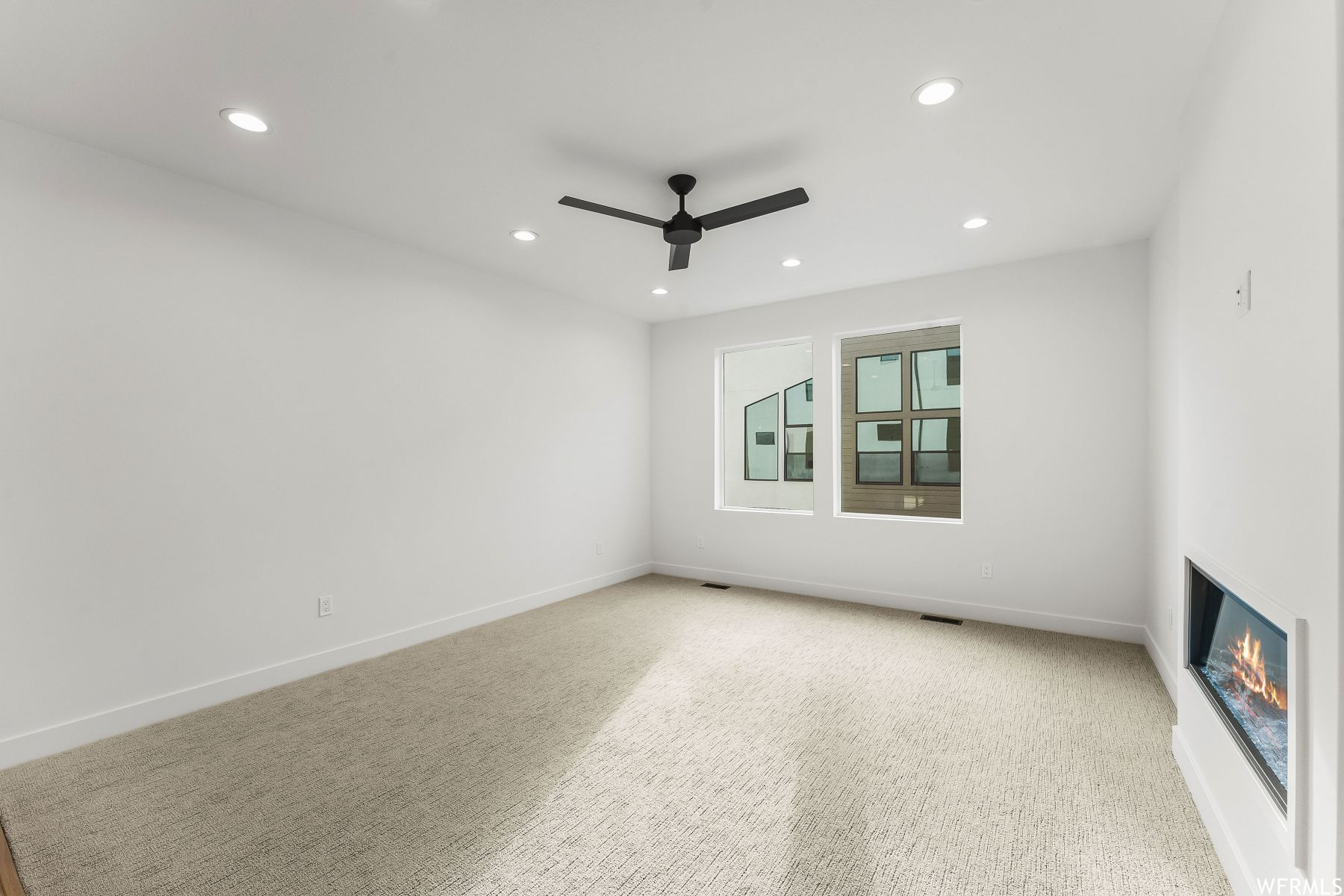 room featuring ceiling fan and light colored carpet