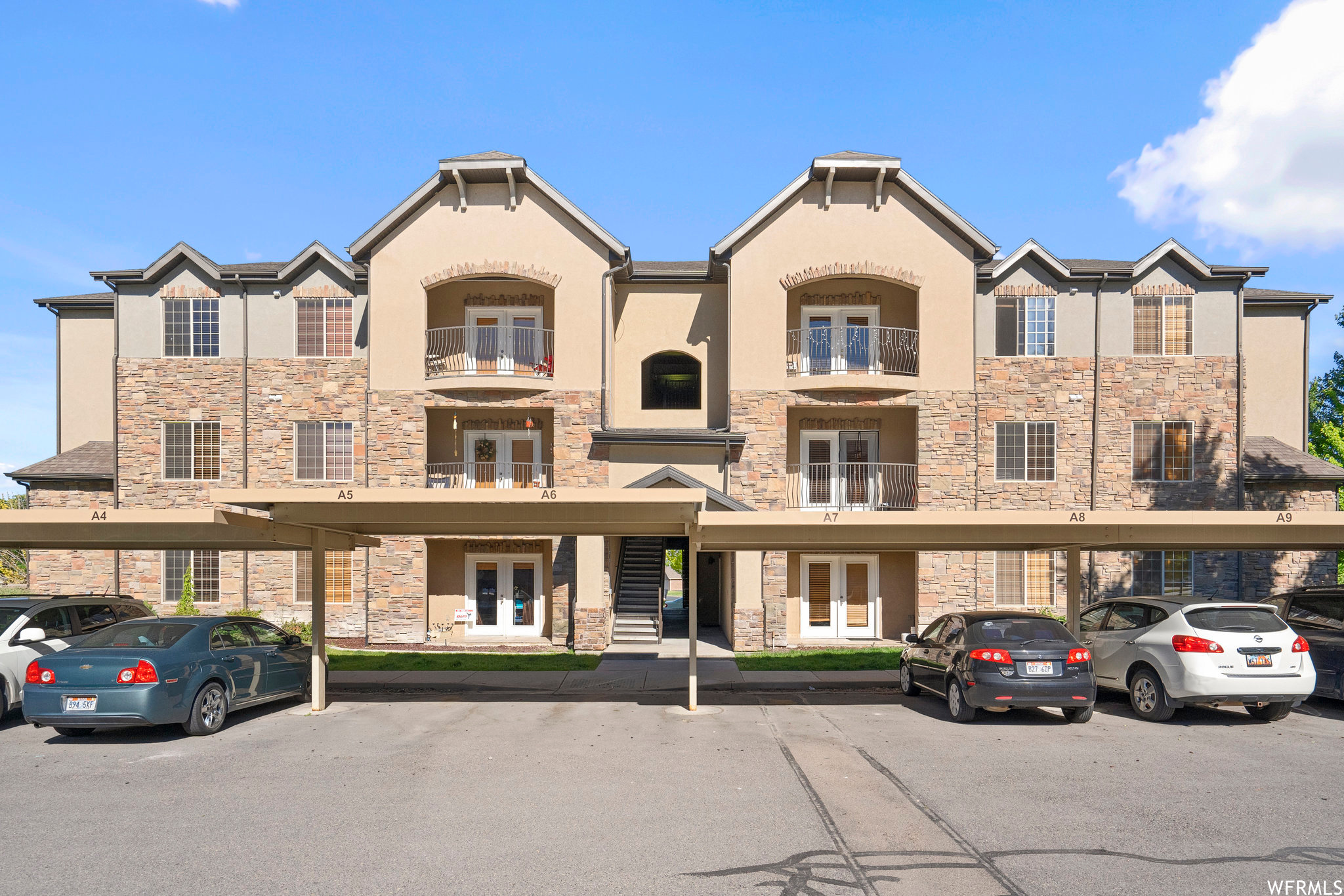 View of front of home featuring balcony and carport