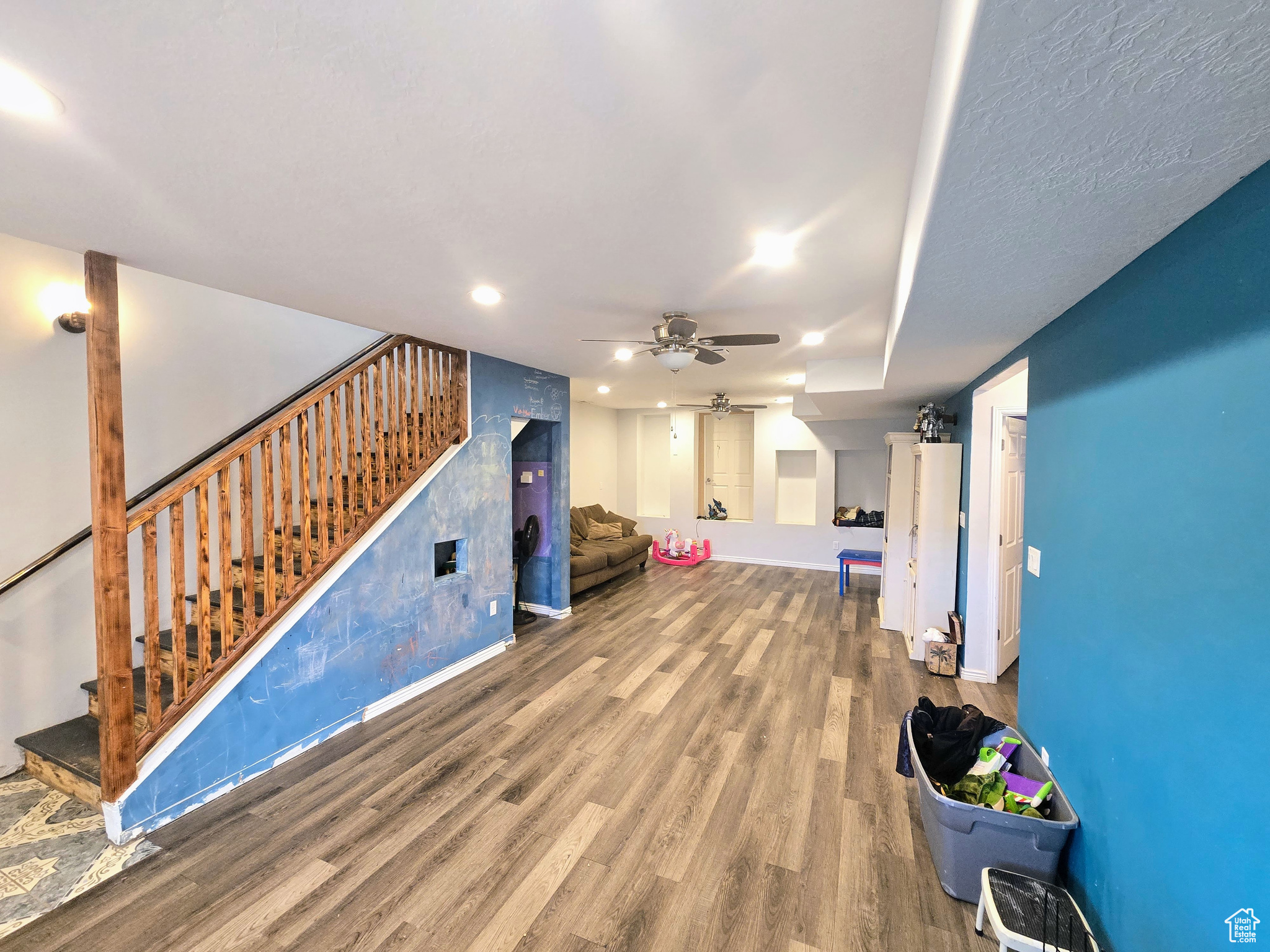 Living room featuring ceiling fan and hardwood / wood-style flooring